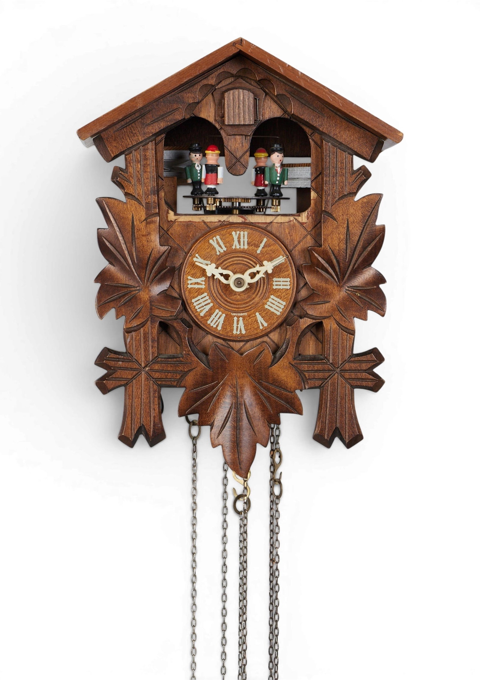 A wooden cuckoo clock: A wooden cuckoo clock height 11 1/2 x width 8 1/2 x depth 5 3/4 in. (29.2 x 21.6 x 14.6 cm.)