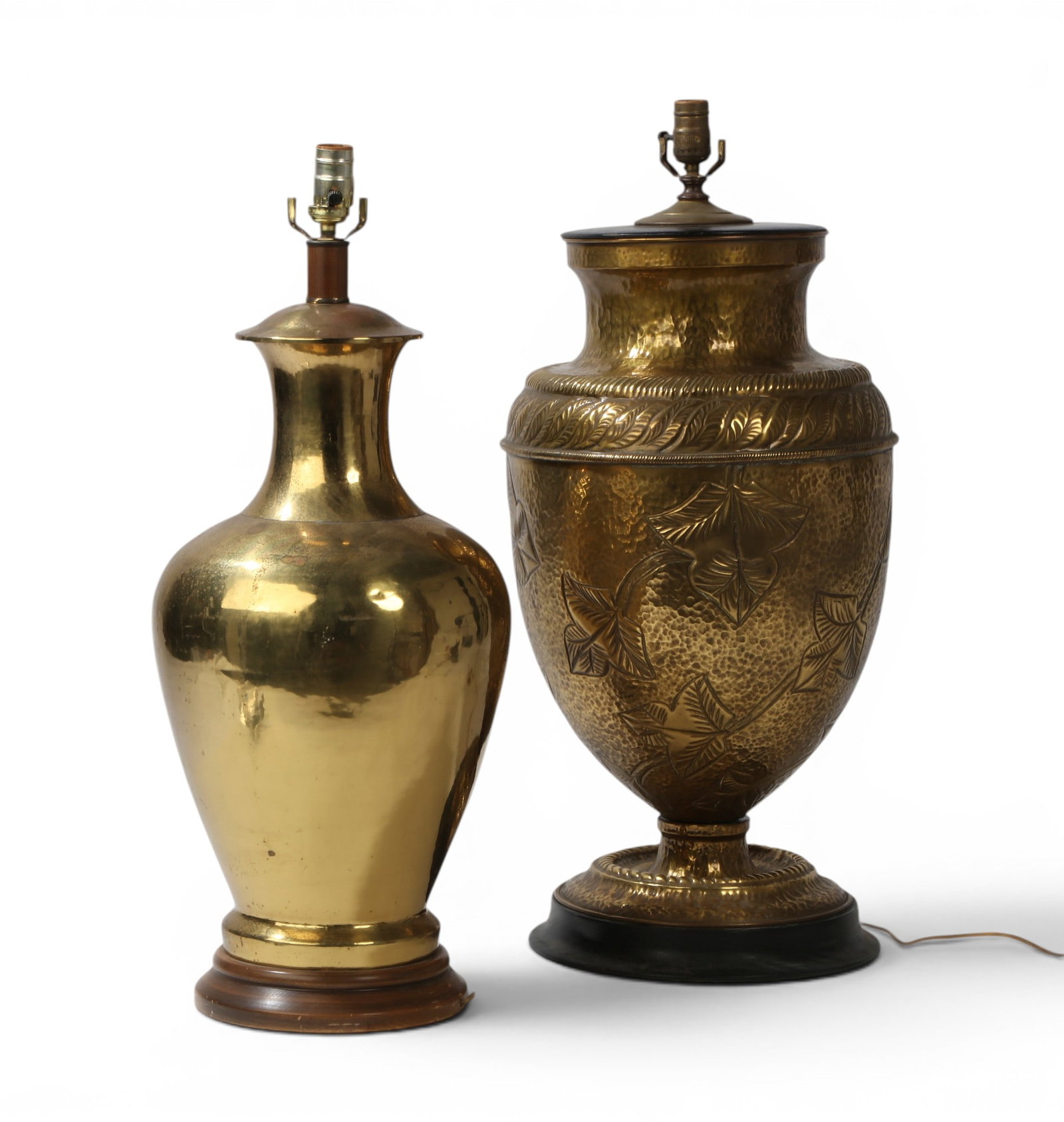 A group of two large brass table tamps: A group of two large brass table tamps Largest: height 29 1/2 x diameter 13 1/2 in. (74.9 x 34.3 cm.)