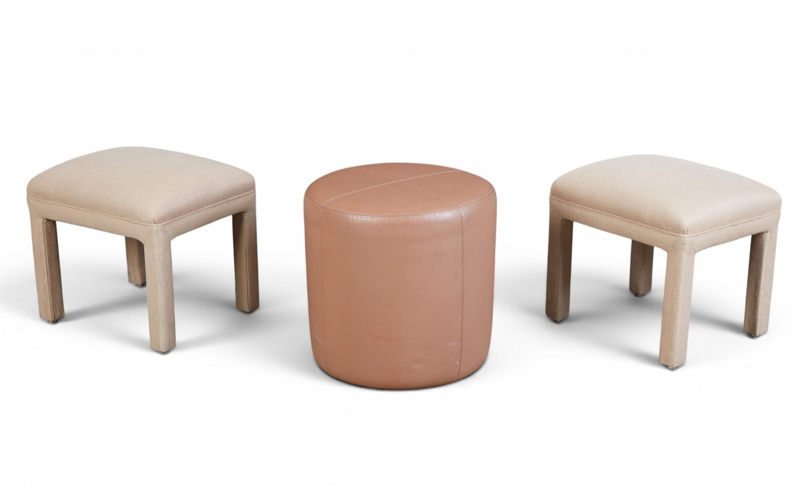 A group of three barstools: A group of three barstools two upholstered, one leather leather stool: height 20 x diameter 20 in. (50.8 x 50.8 cm.)