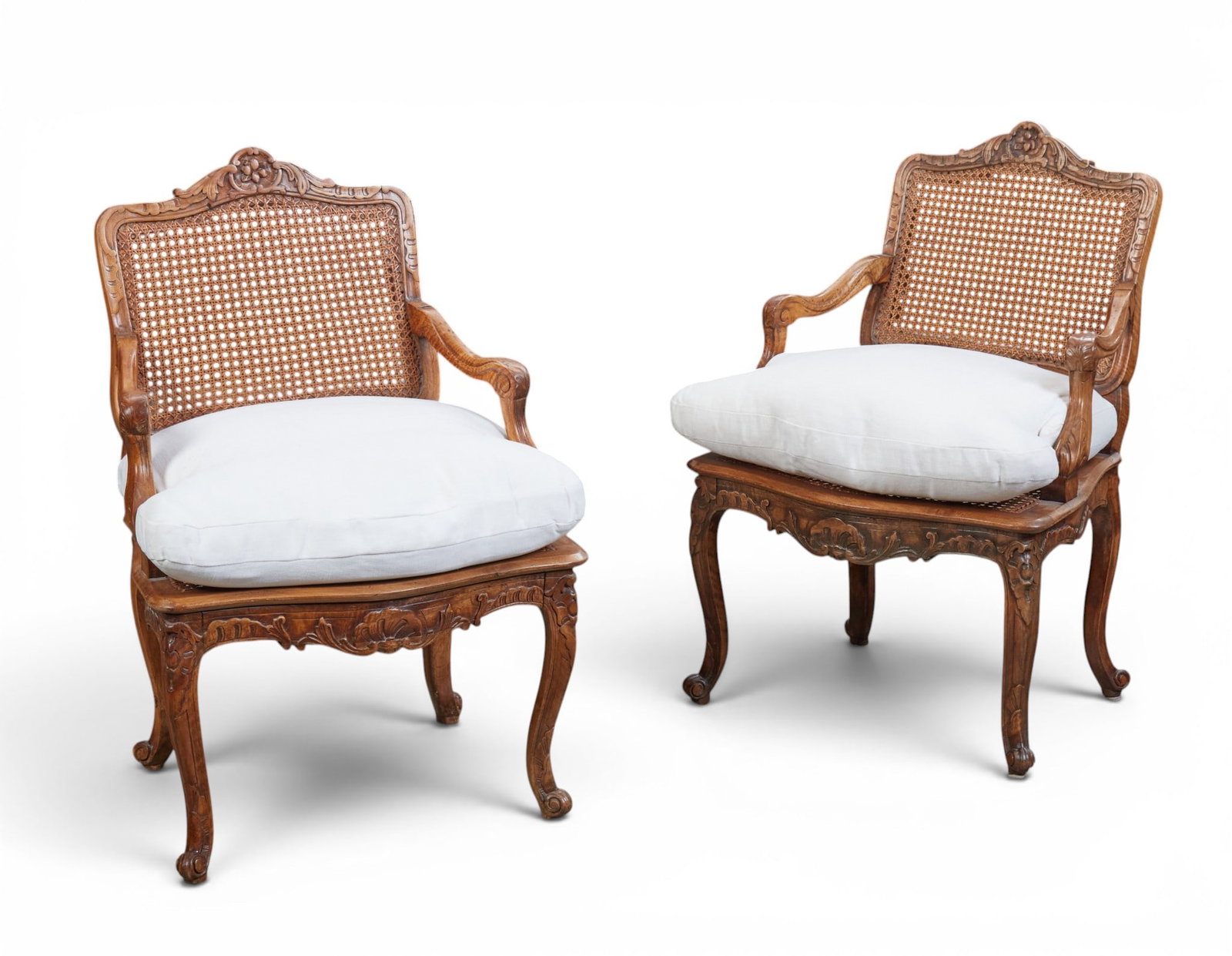 A pair of Louis XV Provincial style caned beechwood fauteuils, late 19th/early 20th century: A pair of Louis XV Provincial style caned beechwood fauteuils late 19th/early 20th century height 37in (94cm); width 25 1/2in (65cm); depth of seat 20in (51cm)