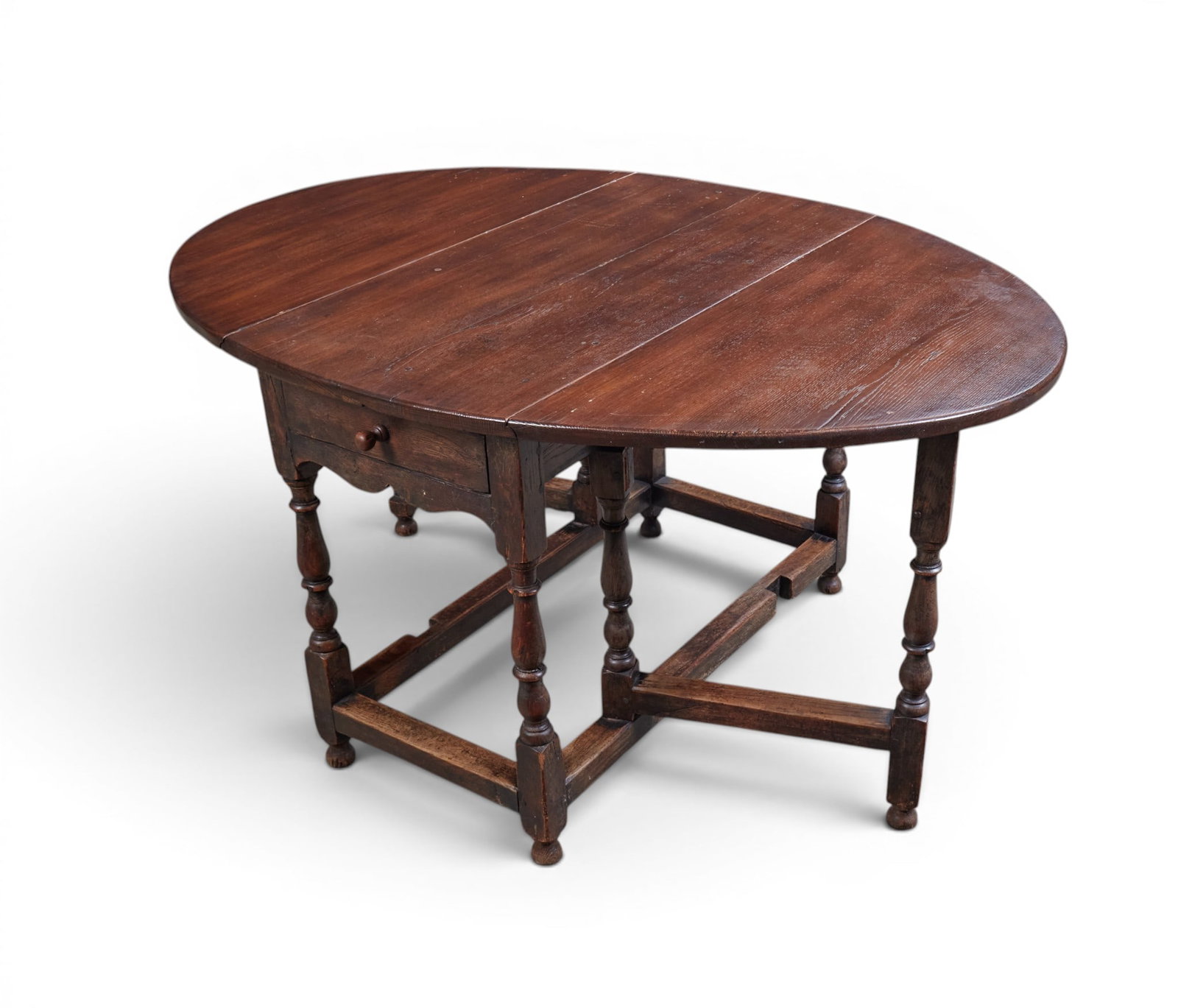 An oval drop leaf table with single drawer: An oval drop leaf table with single drawer height 28 x width 58 x depth 40 in. (71.1 x 147.3 x 101.6 cm.)