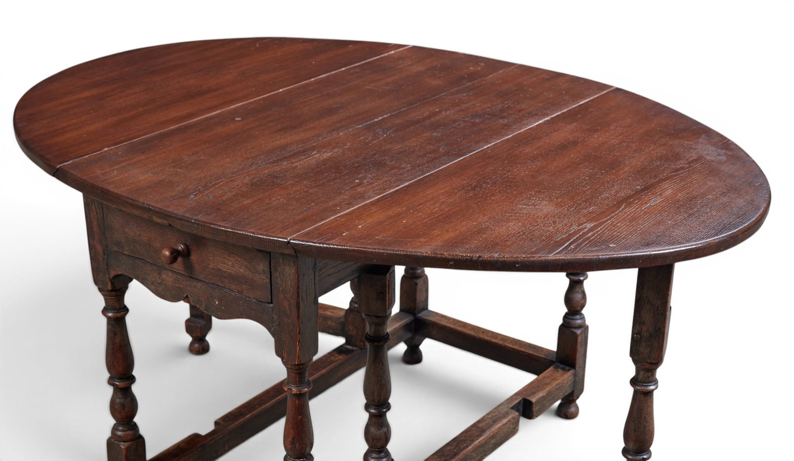 An oval drop leaf table with single drawer - 6