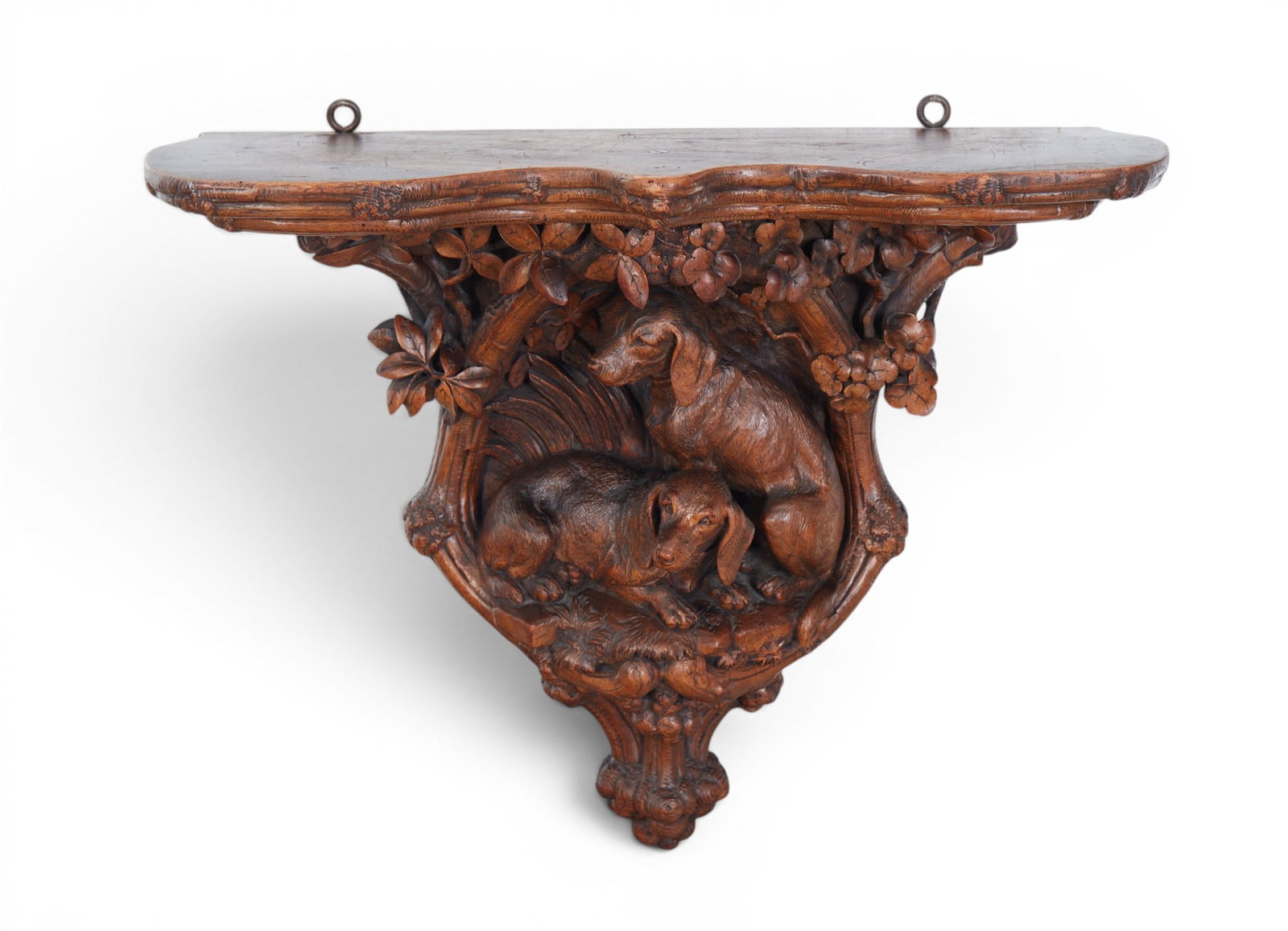 A Black Forest linden wood canine wall bracket, late 19th century: A Black Forest linden wood canine wall bracket late 19th century height 20 1/2in (52cm); width 26 1/2in (67.5cm); depth 11 3/4in (30cm) Provenance: Property from the Collection of Ben Nysewander, Carm