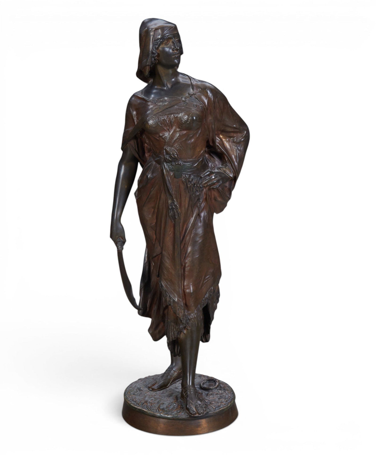 A French patinated bronze model of Judith, after a model by Eduard Drouot (1859-1945): A French patinated bronze model of Judith after a model by Eduard Drouot (1859-1945) late 19th century Standing holding a swords, with cabachon ring on finger of left hand, base inscribed E Drouot. he