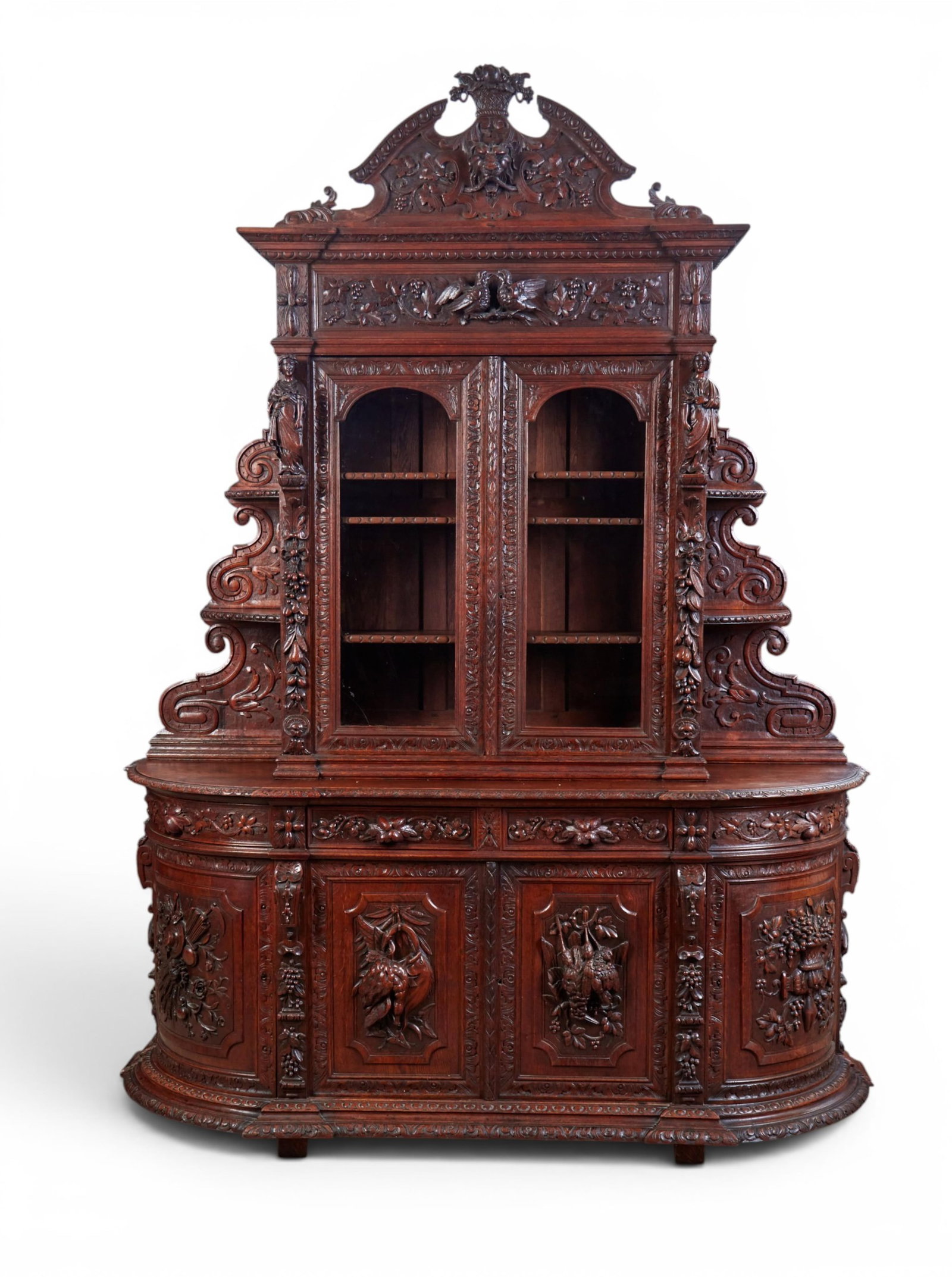 A Continental Renaissance style oak buffet, late 19th/early 20th century: A Continental Renaissance style oak buffet late 19th/early 20th century The upper section with three adjustable shelves flanked by graduated open shelves over an outset base with a pair of frieze draw