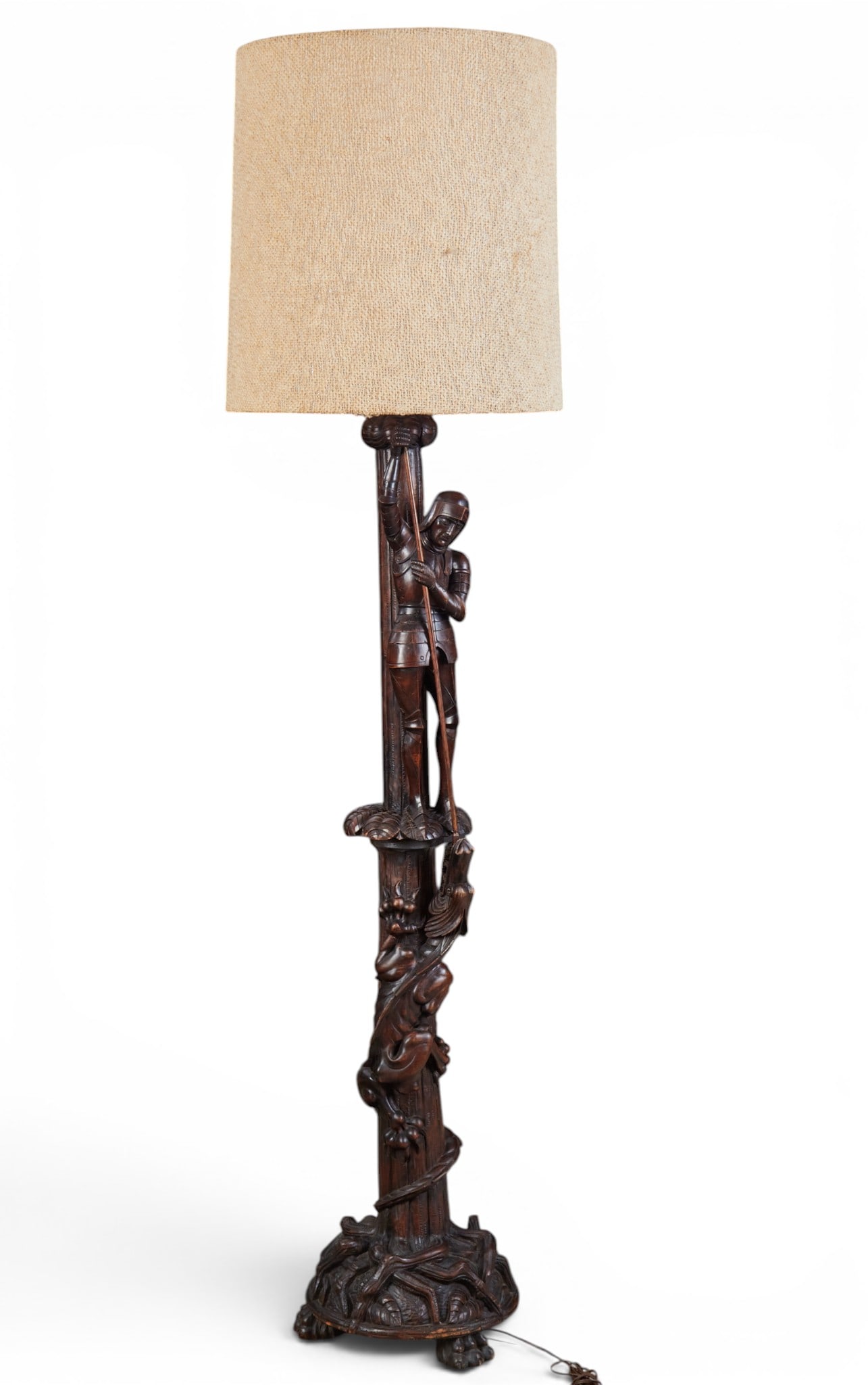 A Continental stained mixed wood St George & the Dragon floor lamp, 20th century: A Continental stained mixed wood St George & the Dragon floor lamp 20th century height to top of finial 74in (188cm); diameter 14in (36cm) Provenance: Property from the Collection of Ben Nysewander, C