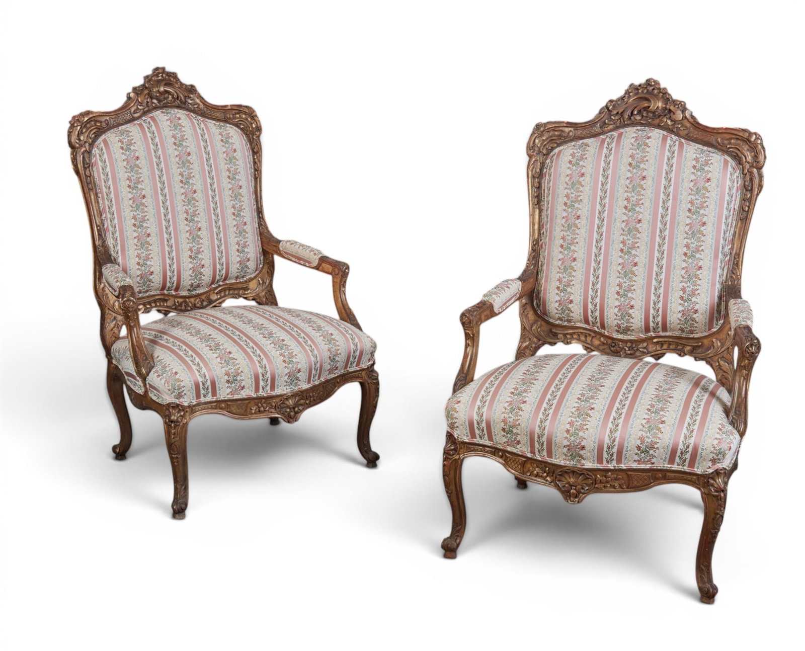 A pair of Louis XV style giltwood fauteuils, 19th century: A pair of Louis XV style giltwood fauteuils 19th century height 49in (124.5cm); width 29in (74cm); depth of seat 24in (61cm) Provenance: Property from the Collection of Ben Nysewander, Carmel, Califor