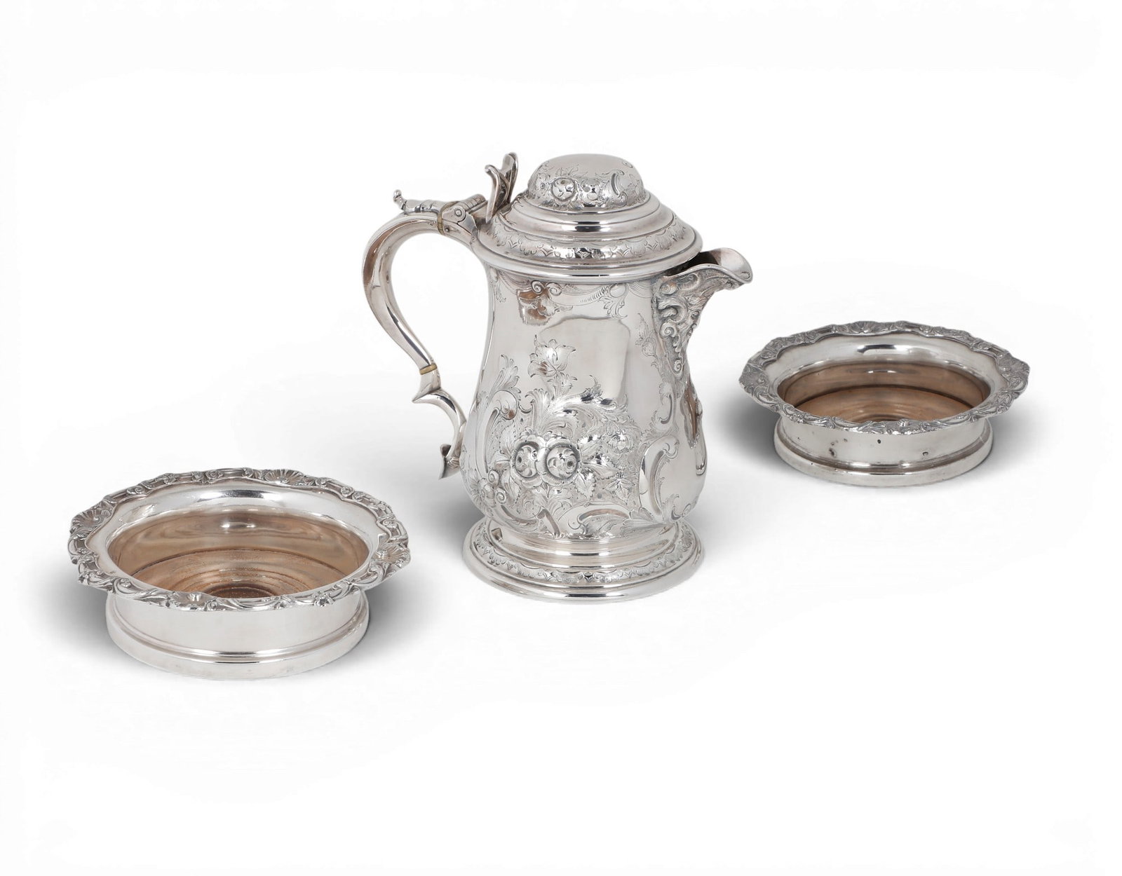 An English silver plate tankard form pitcher and a pair of wine coasters, Martin, Hall & C: An English silver plate tankard form pitcher and a pair of wine coasters Martin, Hall & Co., Sheffield and another maker 19th century (3) pitcher height 9 1/4in (23.5cm); length 9in (23cm); width 5 1/