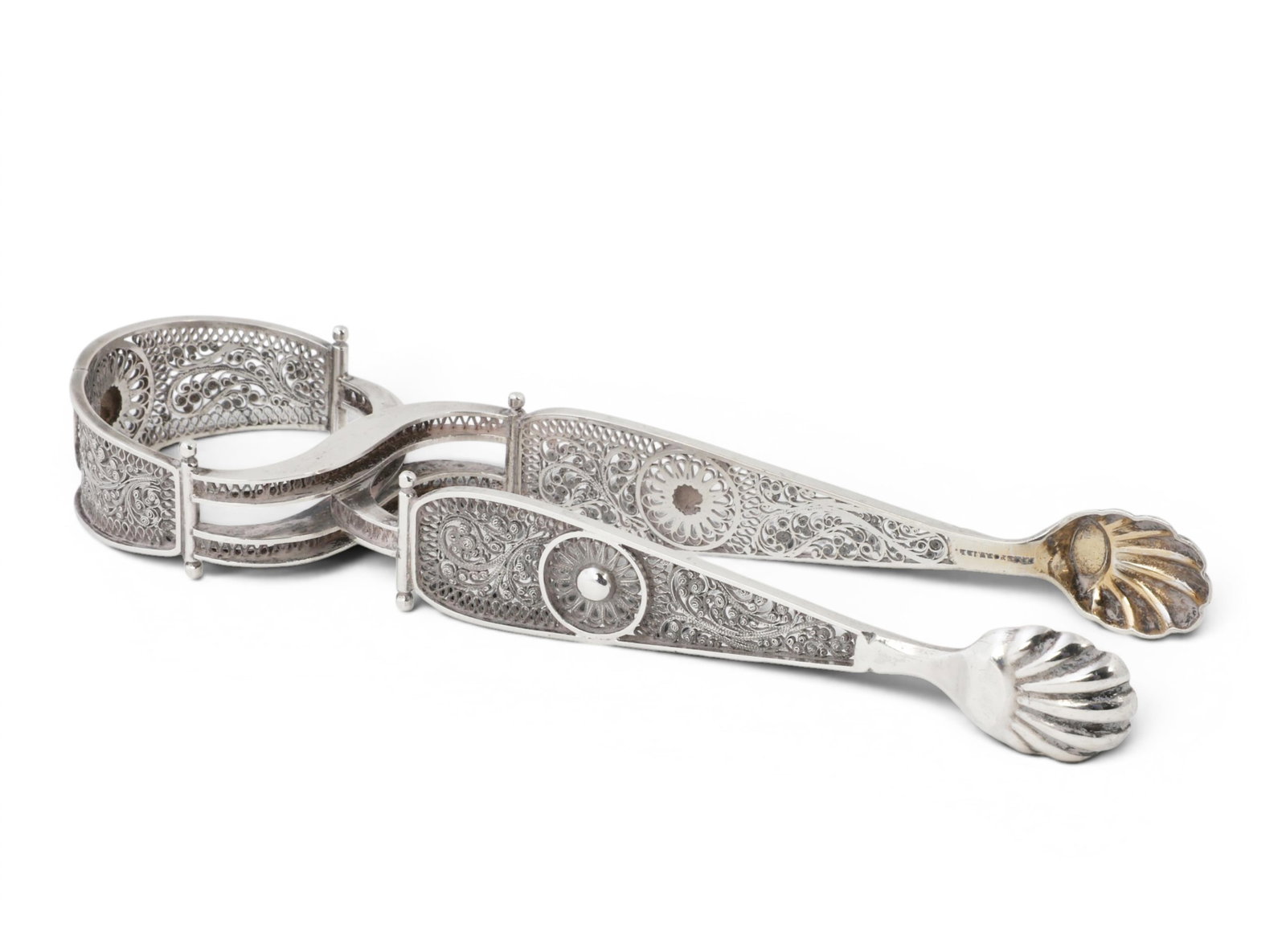 A pair of Gerrit Dirksen silver filigree tongs, late 19th/early 20th century: A pair of Gerrit Dirksen silver filigree tongs late 19th/early 20th century length 7in (18cm); weight approximately 2oz troy Provenance: Property from the Collection of Ben Nysewander, Carmel, Califor