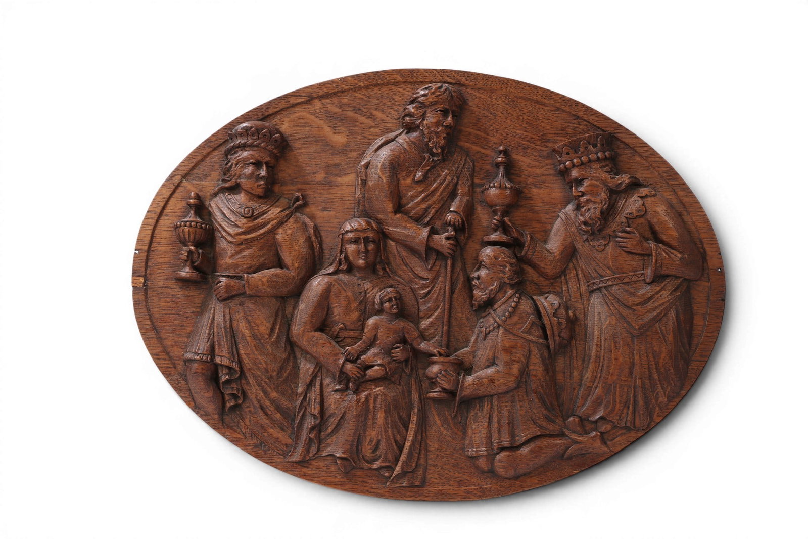 A Continental carved oak oval figural relief plaque: Adoration of the Maji, 19th century: A Continental carved oak oval figural relief plaque: Adoration of the Maji 19th century 13 1/2 x 18 1/2in (34 x 47cm) Provenance: Property from the Collection of Ben Nysewander, Carmel, California.