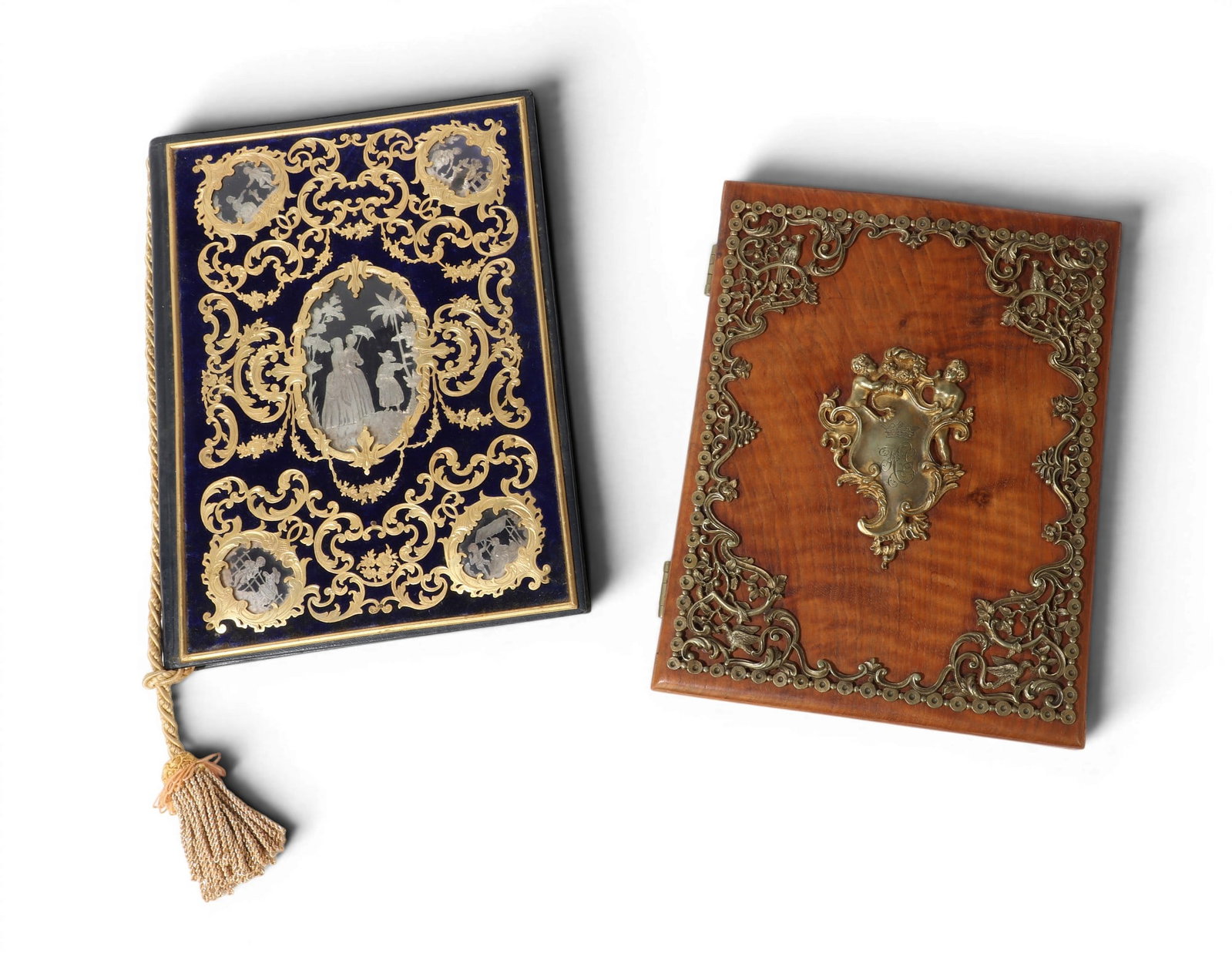 Two Victorian brass mounted desk blotters, circa 1900: Two Victorian brass mounted desk blotters circa 1900 Comprising a walnut blotter centered by a brass cartouche with engraved monogram HG below a coronet and a navy leather, blue velvet, and brass moun