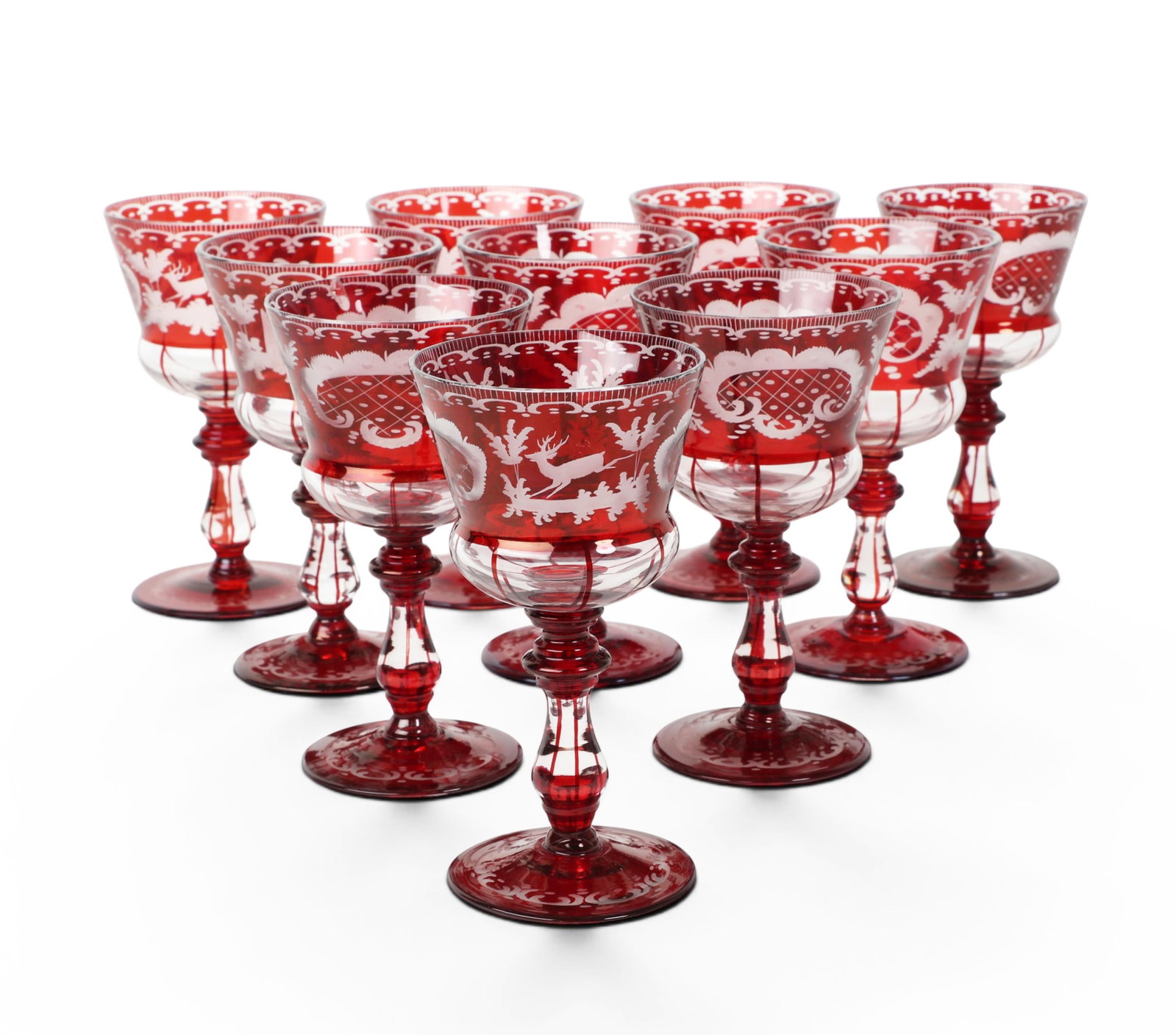 A set of ten Bohemian ruby cut to clear acid etched wine glasses, late 19th century: A set of ten Bohemian ruby cut to clear acid etched wine glasses late 19th century Depicting a castle and a stag in forest landscape. height 6in (15cm); diameter 3 1/4in (8cm) Provenance: Property