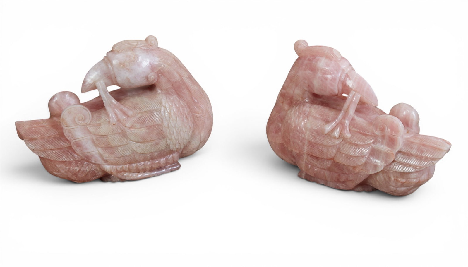 An large pair of Chinese rose quartz models of phoenix: An large pair of Chinese rose quartz models of phoenix height 17in (43cm); length 23in (58.5cm); width 8in (20.5cm)