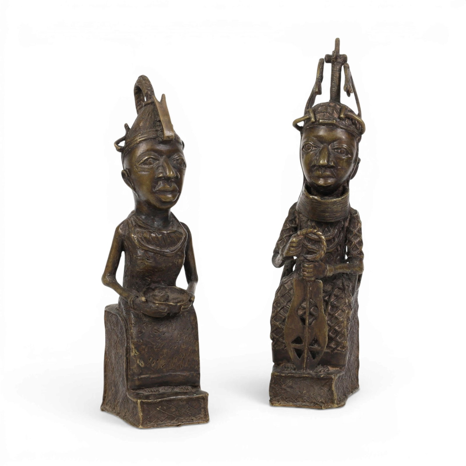 Two Benin bronze figures: Two Benin bronze figures Height of tallest 14 1/4in (36cm); width 4in (10cm); depth 4 1/2in (11.5cm) Provenance: Property from the collection of Frederick M Nicholas, Beverly Hills, California.