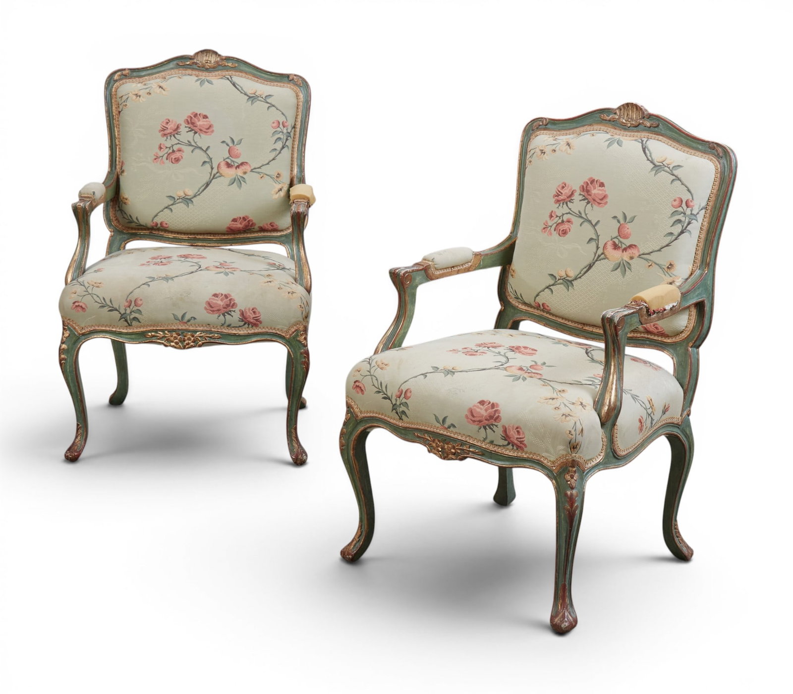 A pair of Louis XV style carved giltwood and green paint decorated fauteuils: A pair of Louis XV style carved giltwood and green paint decorated fauteuils late 19th/20th century height 40in (101.5cm); width 25 1/4in (64cm); depth of seat 21in (53.5cm)