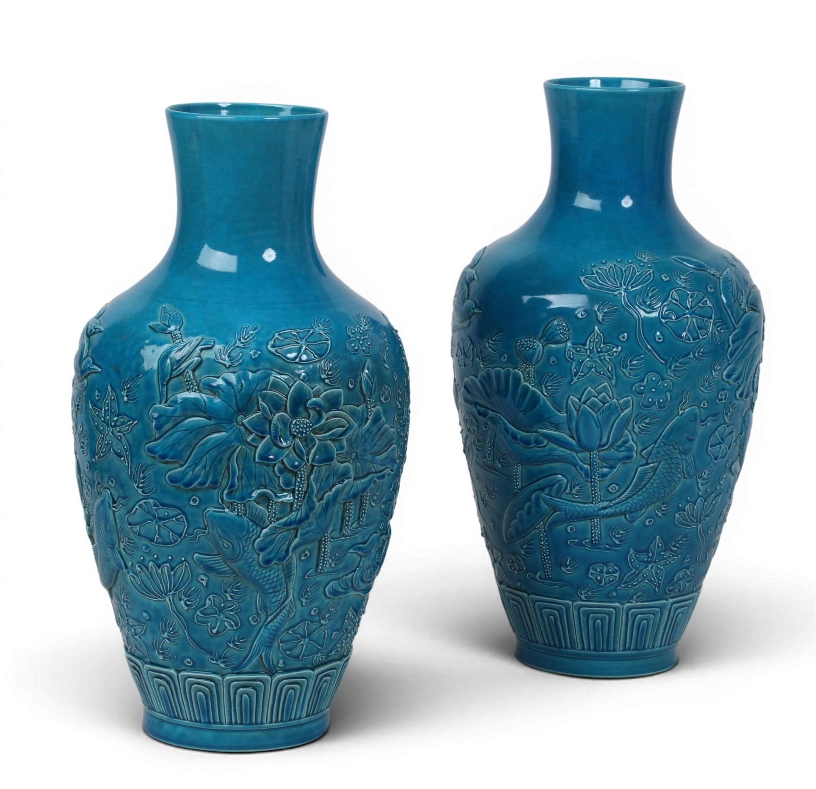 A pair of Chinese turquoise glazed porcelain vases: A pair of Chinese turquoise glazed porcelain vases Each with a square character seal stamp to underside. height 18in (46cm); diameter 9 1/2in (24cm)