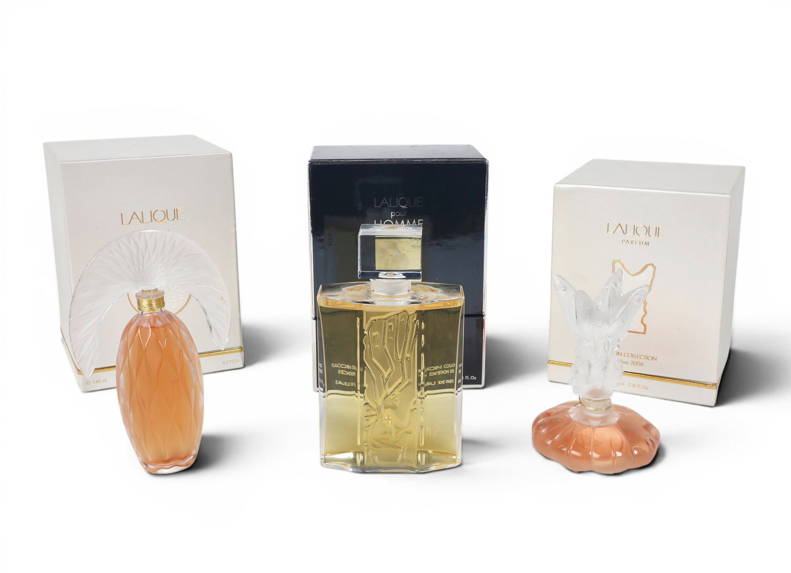 Three vintage limited edition Lalique parfum flacons, early 21st century: Three vintage limited edition Lalique parfum flacons early 21st century Comprising Icare (Homme, 2006), Les Fees (2006) and Commedia (2007), each with box, two with certificate. tallest bottle height 