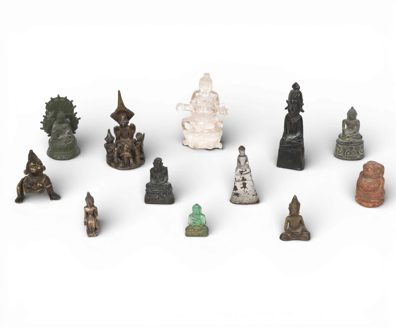 A twelve piece collection of Asian mixed media amulets and figures (1 of 3)