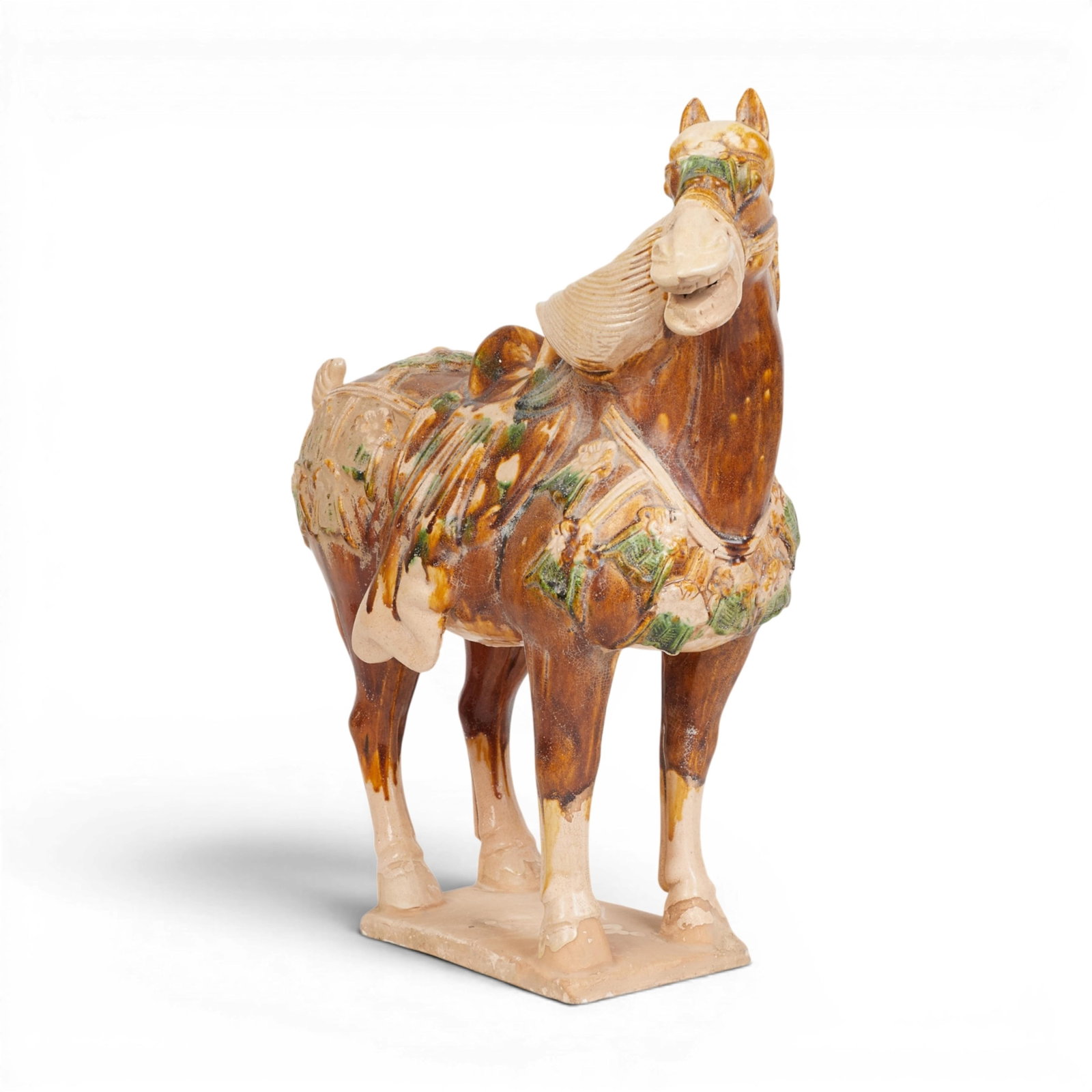 A Chinese sancai glazed pottery model of a horse: A Chinese sancai glazed pottery model of a horse height 19 1/2in (50cm); length 19in (48cm); width 9in (23cm)