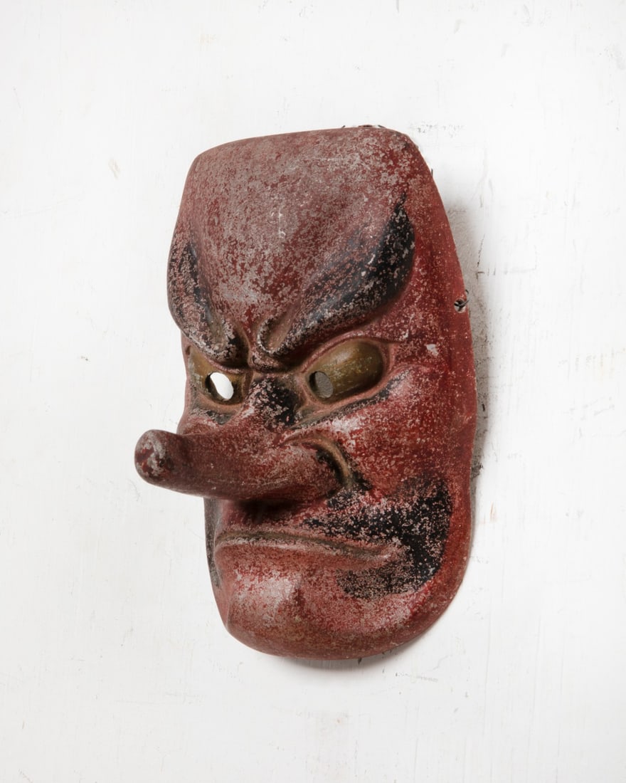 A Japanese polychrome decorated cast white metal Tengu mask: A Japanese polychrome decorated cast white metal Tengu mask height 7in (18cm); width 5in (13cm); depth 3 1/2in (9cm)