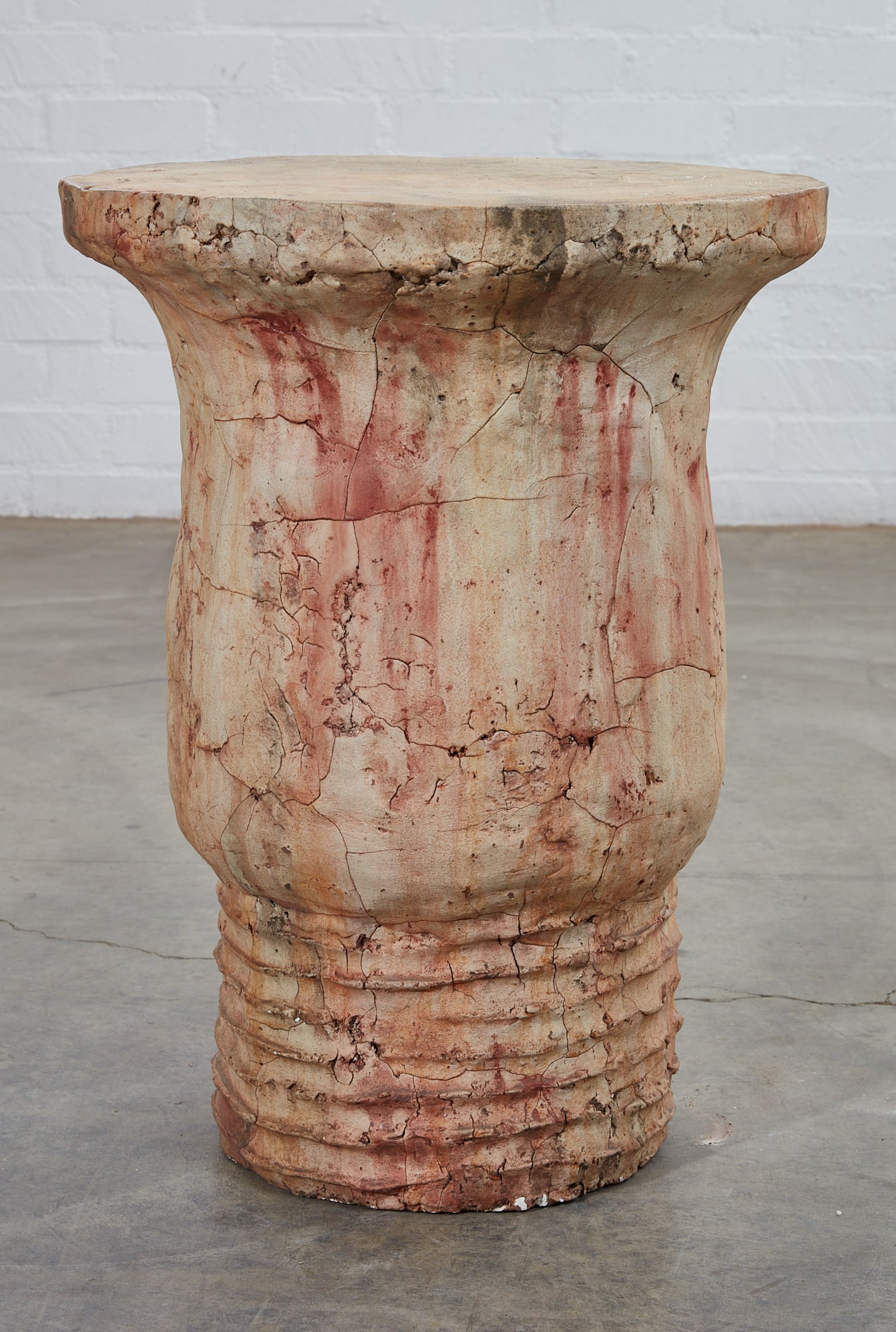 A composition faux stone drum form table, modern: A composition faux stone drum form table modern height 27 3/4in (70.5cm); diameter 20 3/4in (53cm)