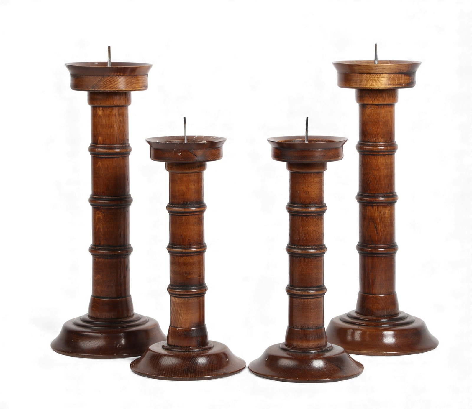 A group of four turned oak pricket candlesticks, modern (1 of 3)