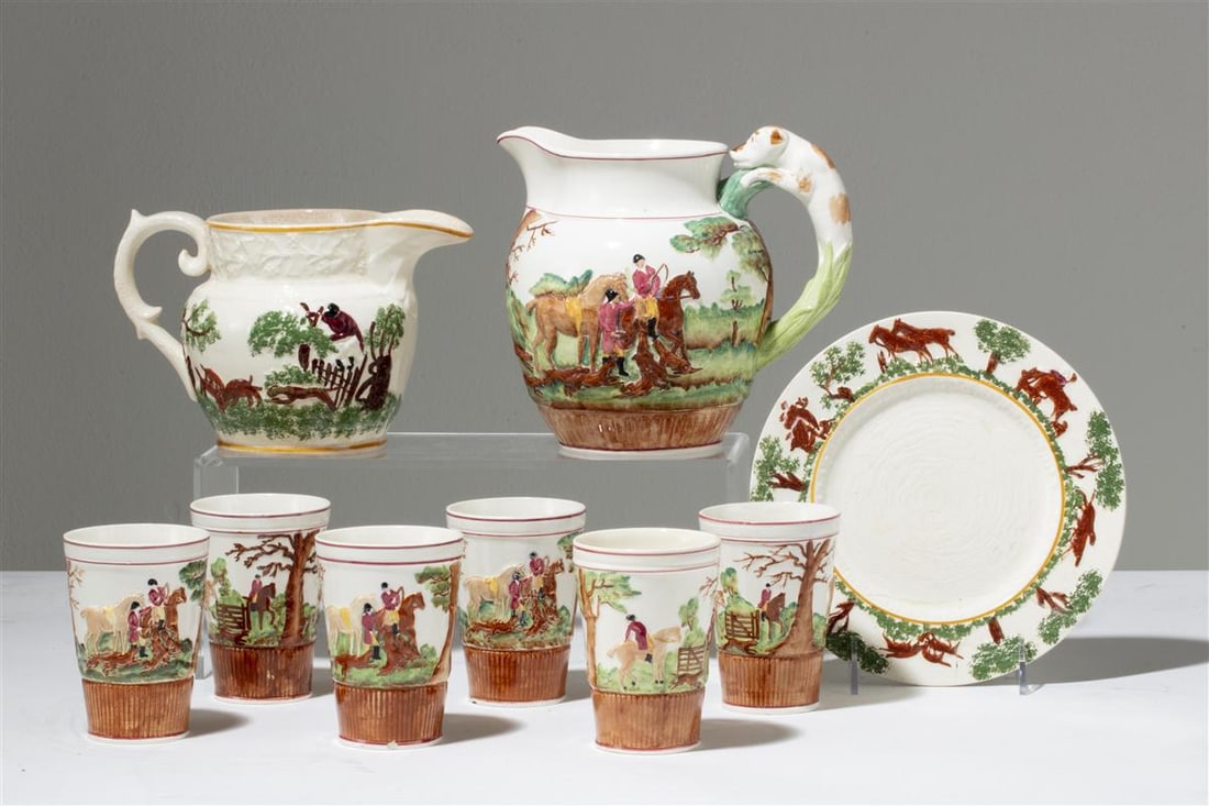A Wedgwood drinks set relief decorated with hunt scenes: A Wedgwood drinks set relief decorated with hunt scenes (9) Comprising pitcher and six beakers, impressed factory marks and painted pattern C5236; together with a similar T.G. Green & Co. 'Old