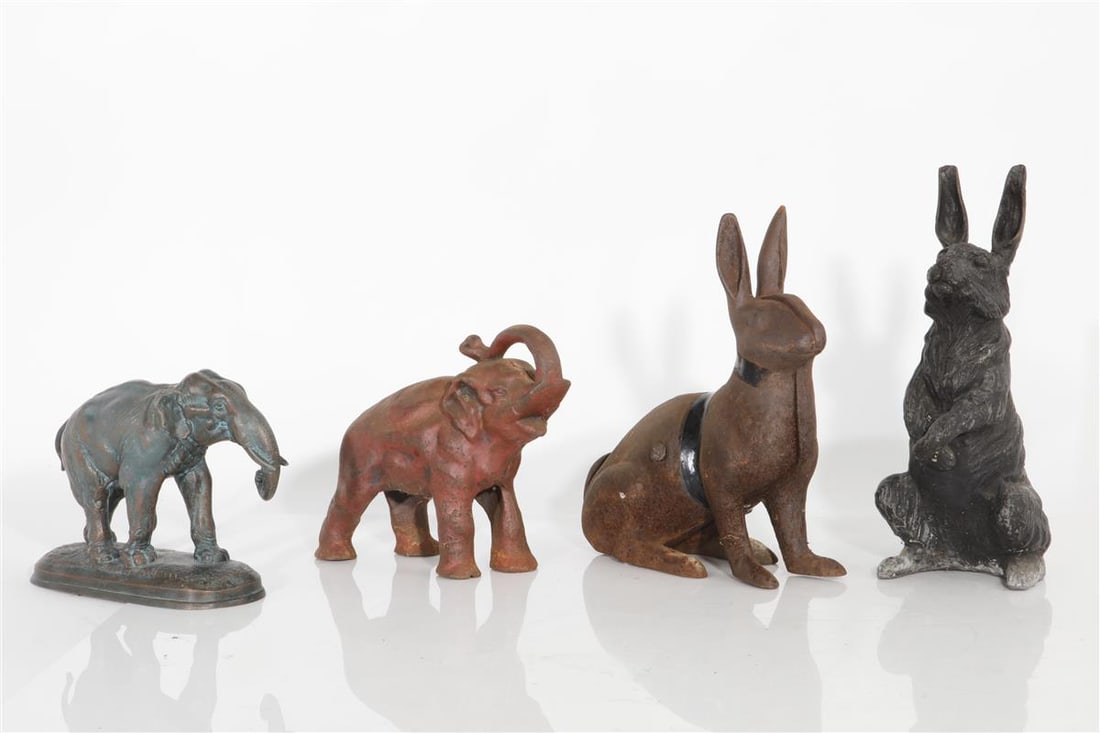 Four cast iron and patinated metal animal figures 20th century: Four cast iron and patinated metal animal figures 20th century Comprising: two rabbits and two elephants. the largest height 12 3/4in (32.5cm)