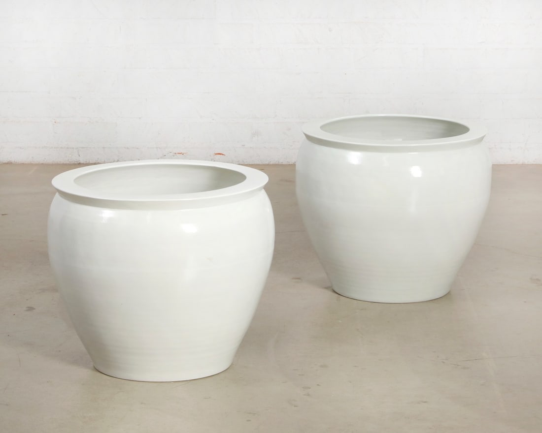 A pair of white glazed earthenware jardinieres, modern: A pair of white glazed earthenware jardinieres modern height 19 1/4in (49cm); diameter 21 3/4in (55cm) Provenance: Property from the Estate of Ed McMahon.