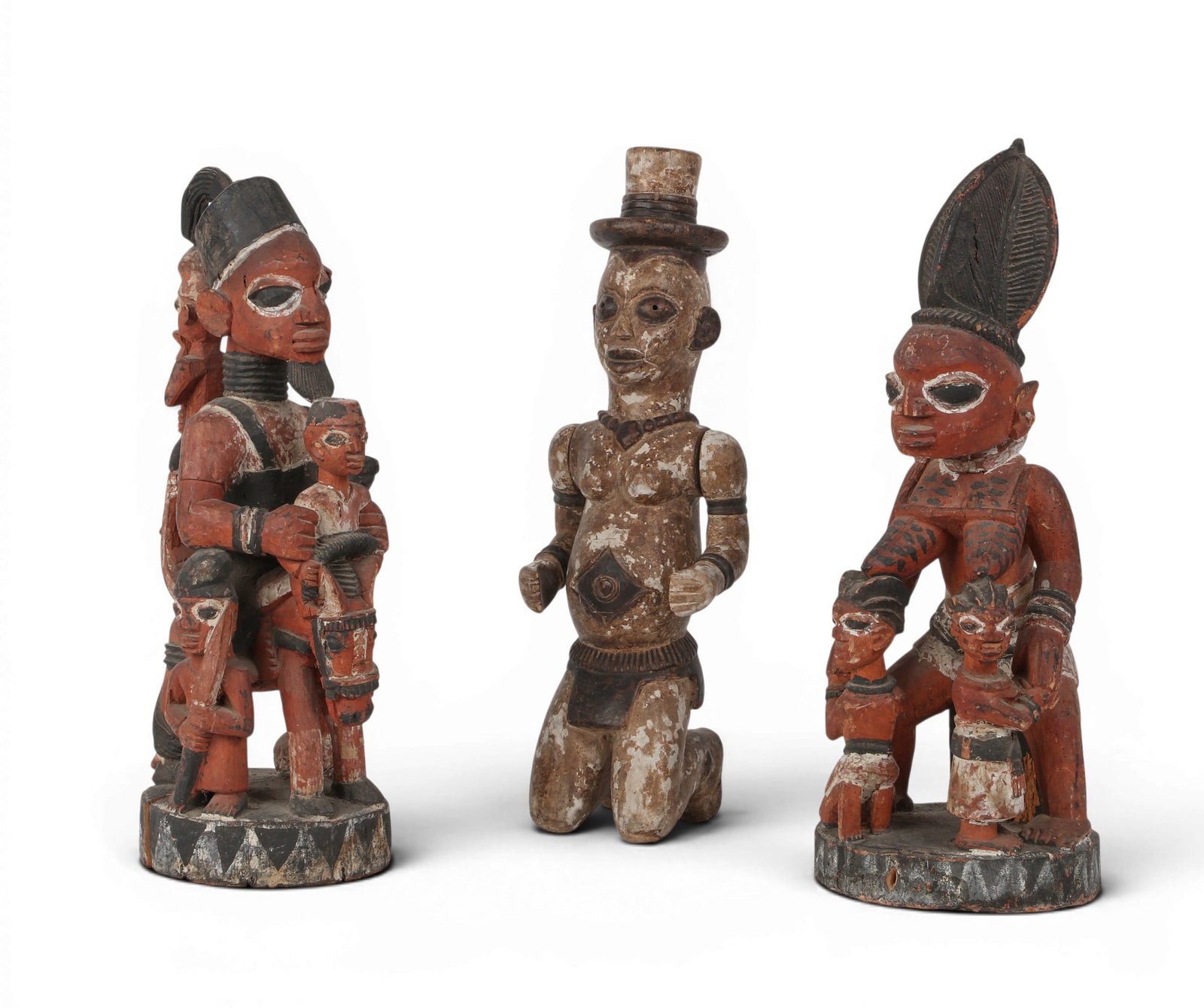 A grouping of three West African Yoruba culture painted wooden ancestral figures (1 of 5)