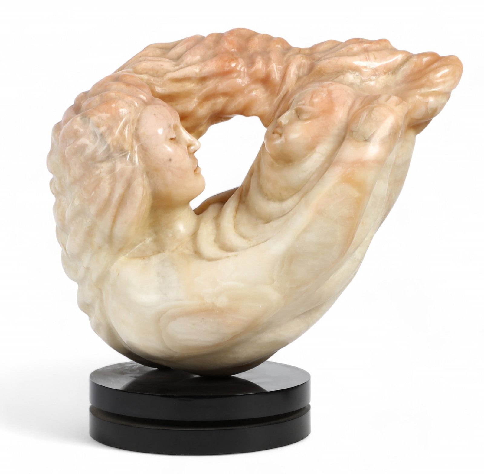 A carved alabaster model of mother and child, modern: A carved alabaster model of mother and child modern Inscribed to reverse GOLDIE / 7-85, on black acrylic rotating plinth. overall 16 1/4 x 18 x 9in (40.5 x 45 x 22.5cm)