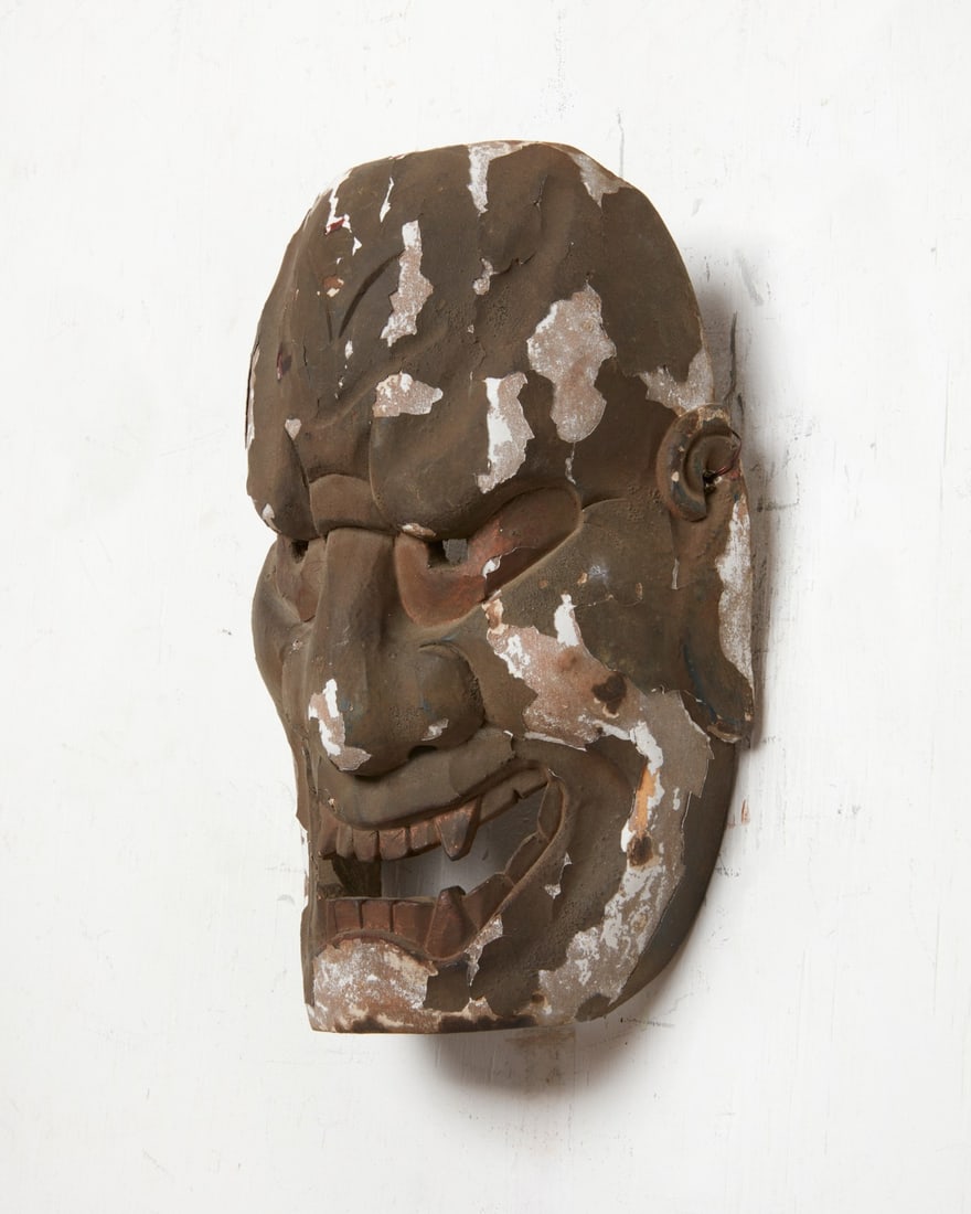 A Japanese black lacquered Oni noh mask: A Japanese black lacquered Oni noh mask height 9 1/4in (23.5cm); width 6 1/2in (16.5cm); depth 3 1/2in (9cm)