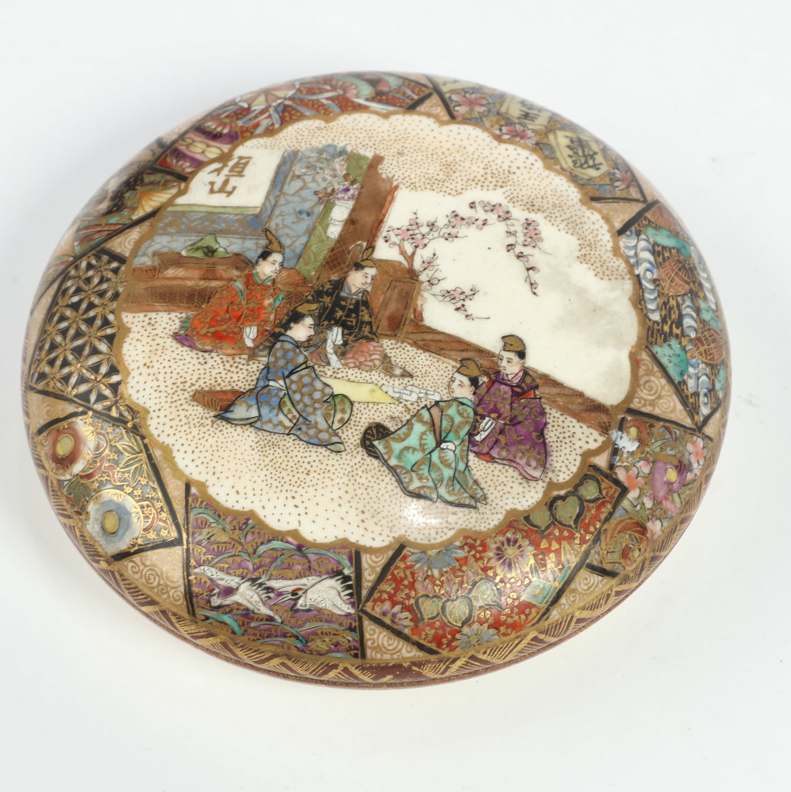 A Japanese satsuma earthenware paste box: A Japanese satsuma earthenware paste box Bearing makers mark reading Kanzan. height 1 1/4in (3cm); diameter 4in (10cm) Provenance: Property from the Estate of Adam Clark Vroman.