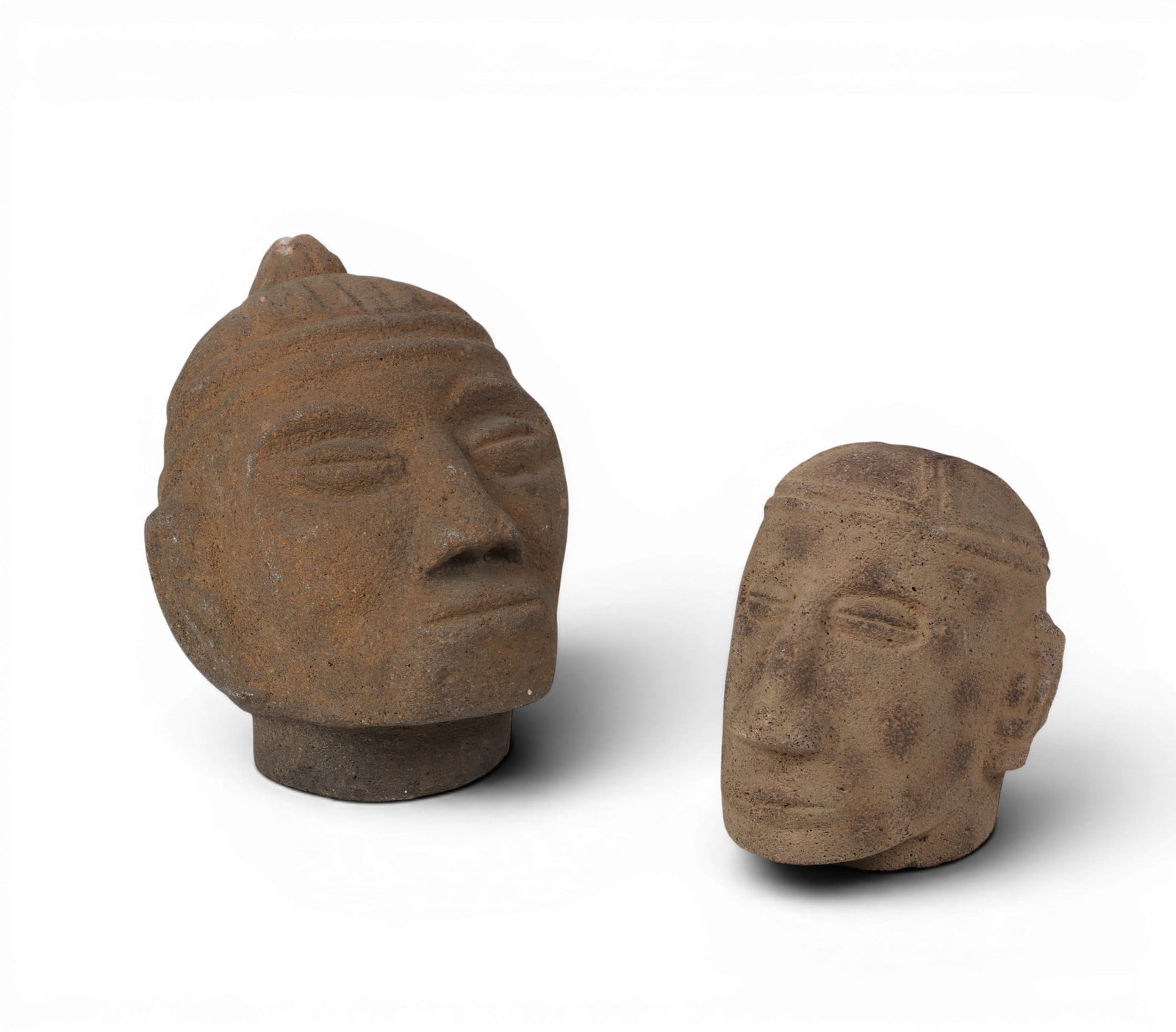 A group of two Mesoamerican volcanic basalt heads (1 of 4)