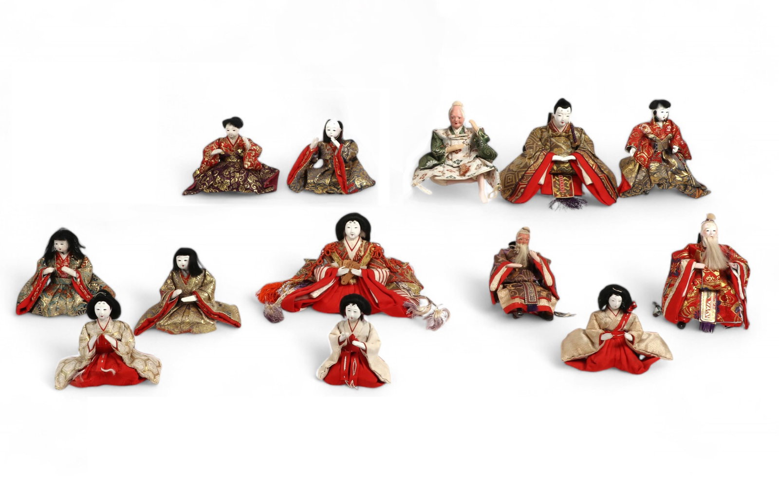 A group of twelve Japanese dolls and a book: A group of twelve Japanese dolls and a book
