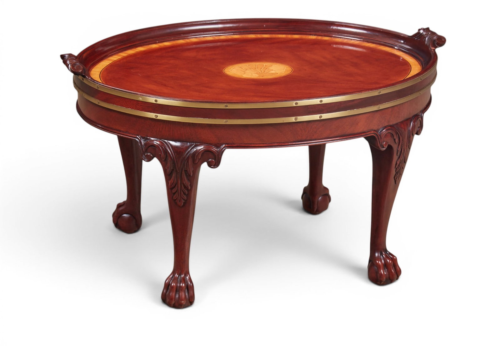 A Baker mahogany coffee table with tray top and marquetry inlay medallion.: A Baker mahogany coffee table with tray top and marquetry inlay medallion. height 19 x width 32 x depth 22 in. (48.3 x 81.3 x 55.9 cm.)
