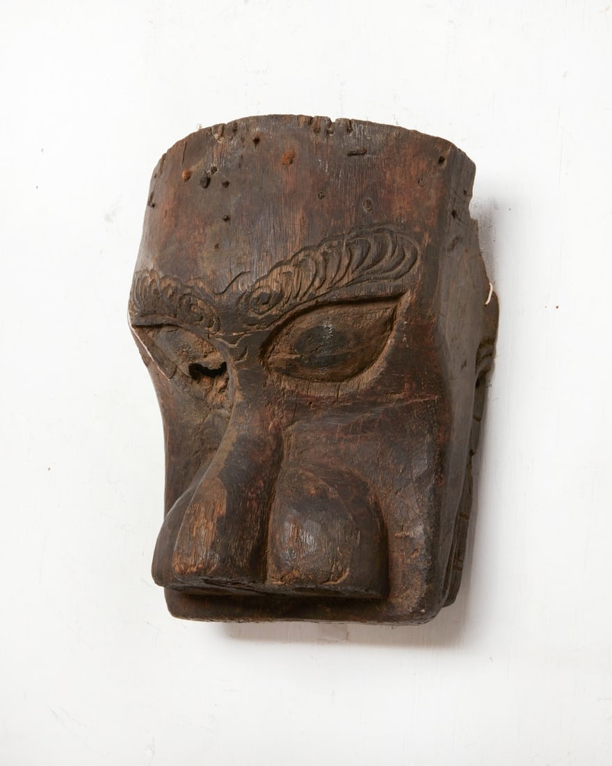 A Japanese ebonized noh mask fragment: A Japanese ebonized noh mask fragment height 11 1/2in (29cm); width 9in (23cm); depth 6in (15cm)