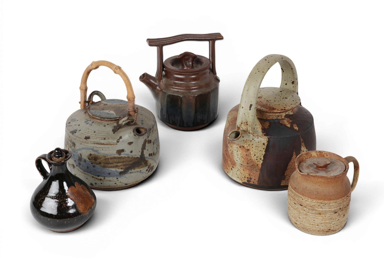 A group of five pottery teapots and jugs: A group of five pottery teapots and jugs Tallest: height 9 in. (22.9 cm.)