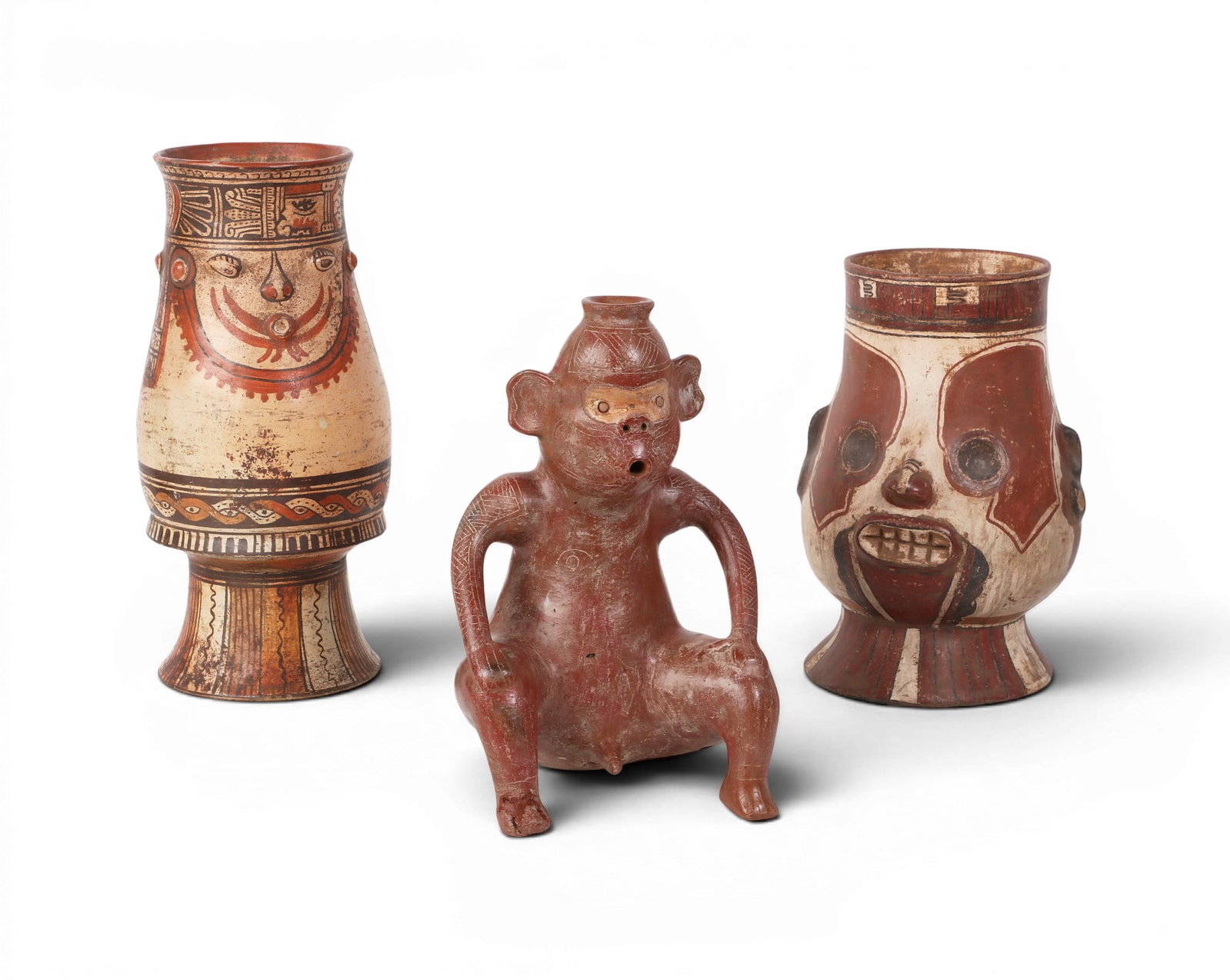 A group of three Mesoamerican polychrome effigy figures: A group of three Mesoamerican polychrome effigy figures lot includes a Colima style (Western Pacific Mexico) seated monkey, possibly fertility vessel; together with two Pataky style Nicoya (Costa