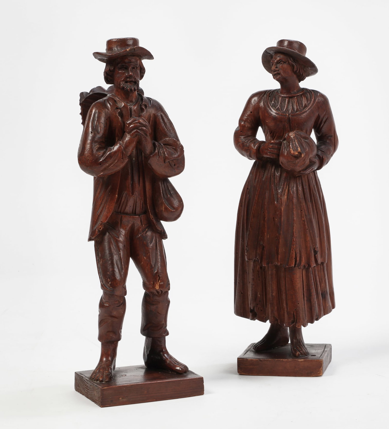 A pair of German carved boxwood figures, late 19th/early 20th century: A pair of German carved boxwood figures late 19th/early 20th century (2) height of largest 14in (35.5cm); width 4 1/4in (10.5cm); depth 5 1/4in (13.5cm)