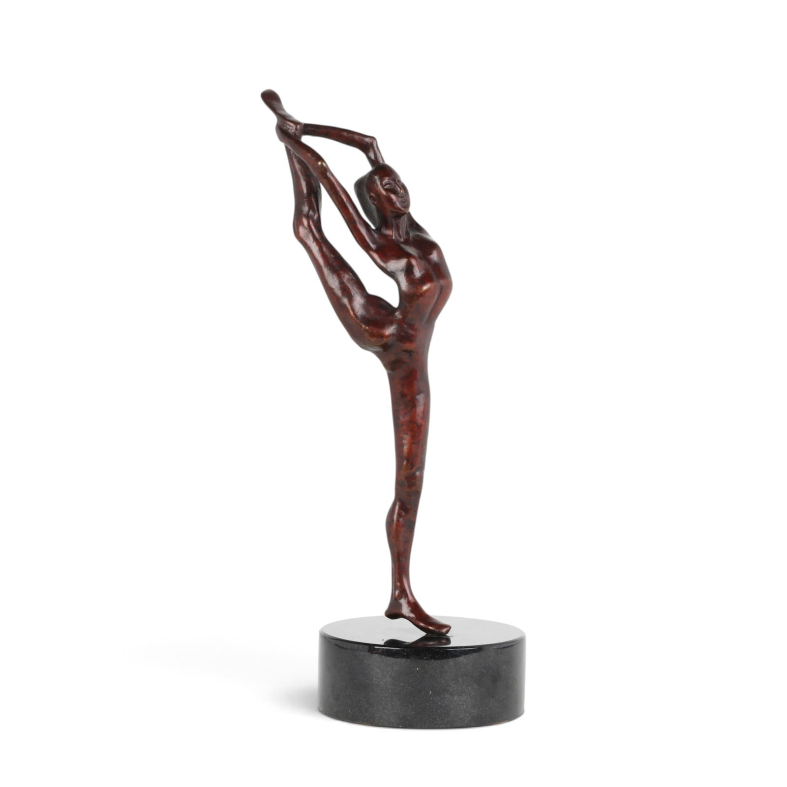 A red patinated bronze model of a dancer in needle scale pose, modern: A red patinated bronze model of a dancer in needle scale pose modern On black granite base. overall height 15in (38cm); width 5in (12.5cm); depth 5 1/2in (14cm)