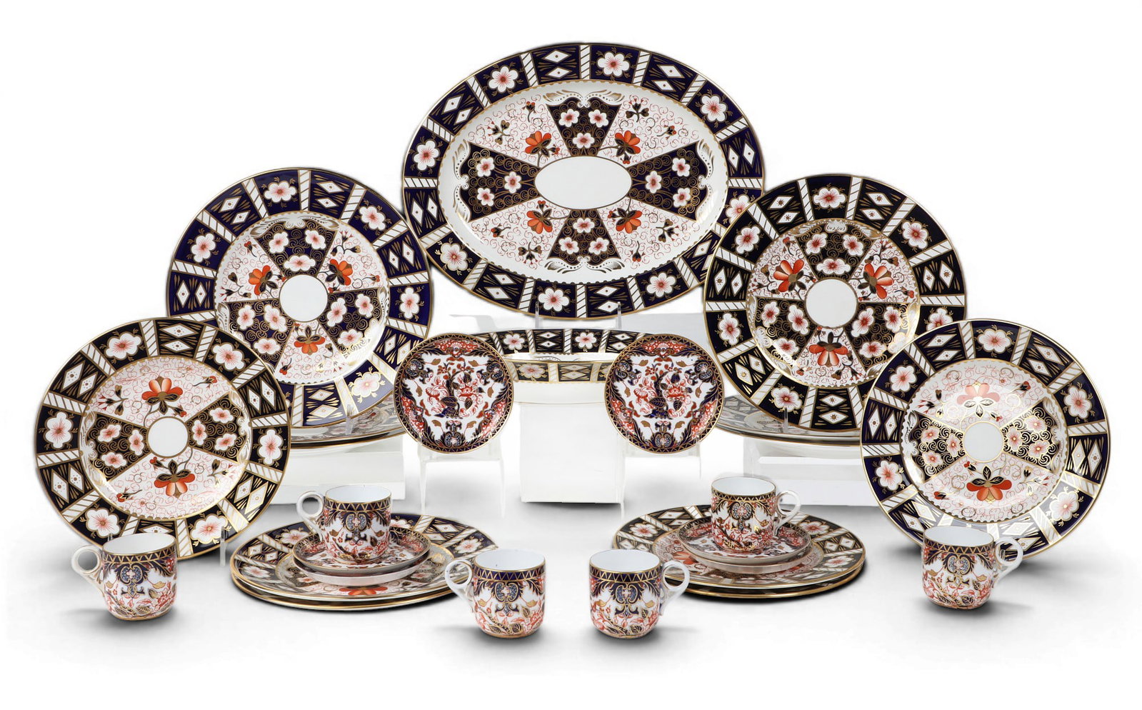 An assembled Royal Crown Derby Imari porcelain part dinner and coffee service, late 19th - early: An assembled Royal Crown Derby Imari porcelain part dinner and coffee service late 19th - early 21st century Comprising six 10 1/2in (26.5cm) dinner plates; six 8 1/2in (21.5cm) salad plates; six demi