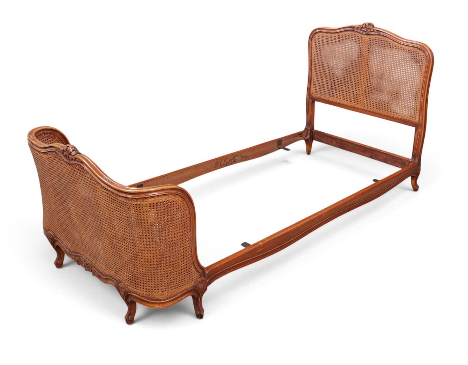 A cane back bed: A cane back bed height 42 x width 39 x length 82 in. (106.7 x 99.1 x 208.3 cm.)