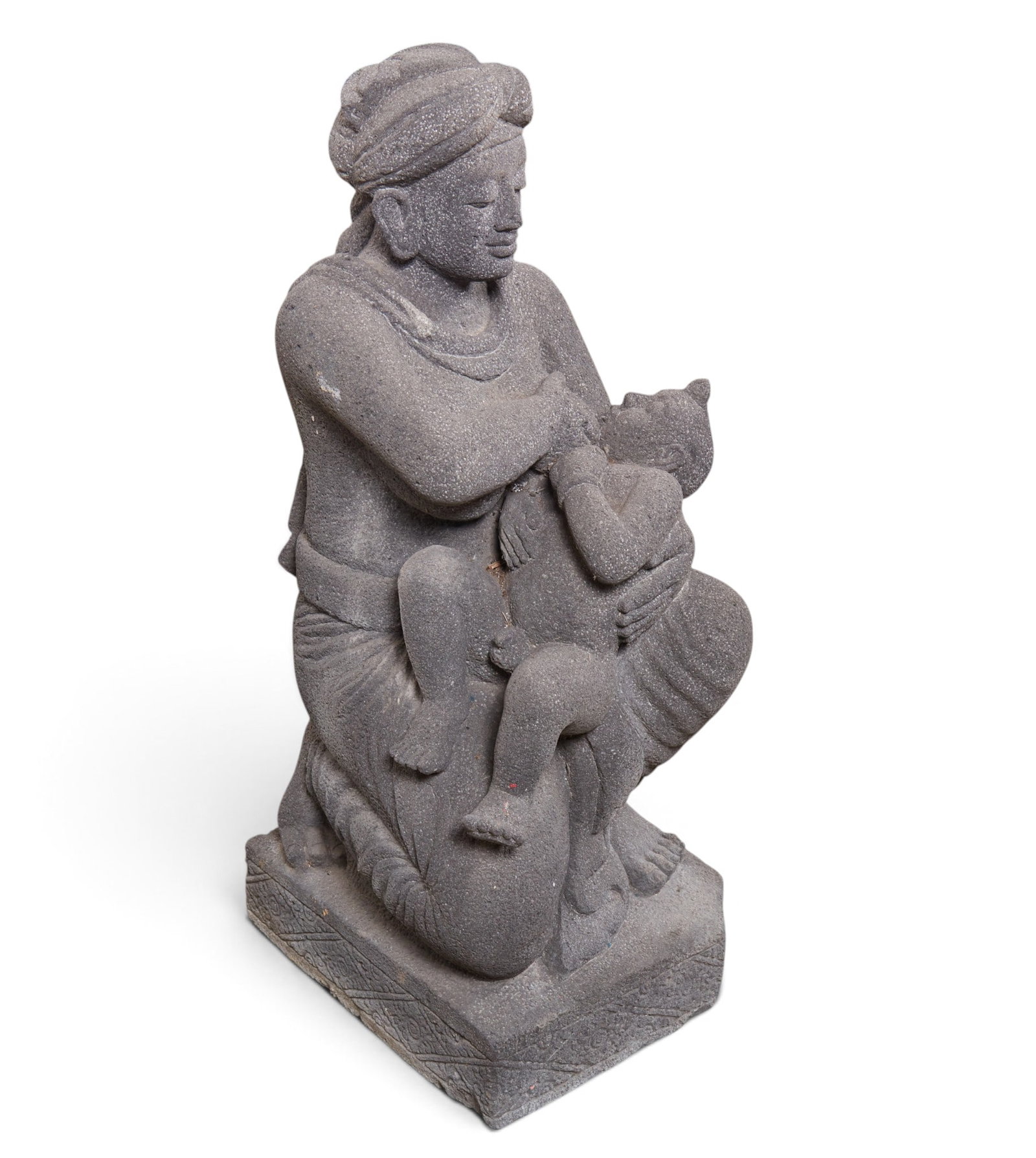 A carved stone of a seated figure with a child.: A carved stone of a seated figure with a child. height 43 x width 15 x depth 19 in. (109.2 x 38.1 x 48.3 cm.)