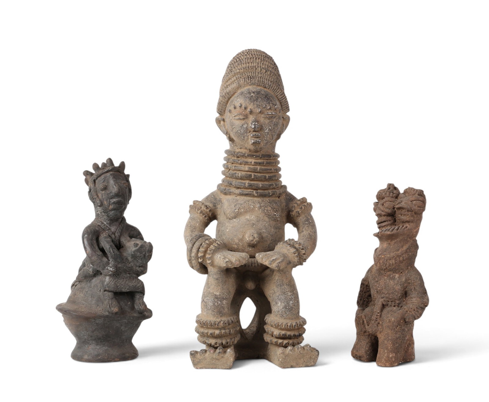 A group of three West/Central Africa clay maternity and devotional figures: A group of three West/Central Africa clay maternity and devotional figures lot includes traditional figures most likely form the Igbo of Nigeria and/or surrounding region. largest: 20 x 8 x 9in (51 x 