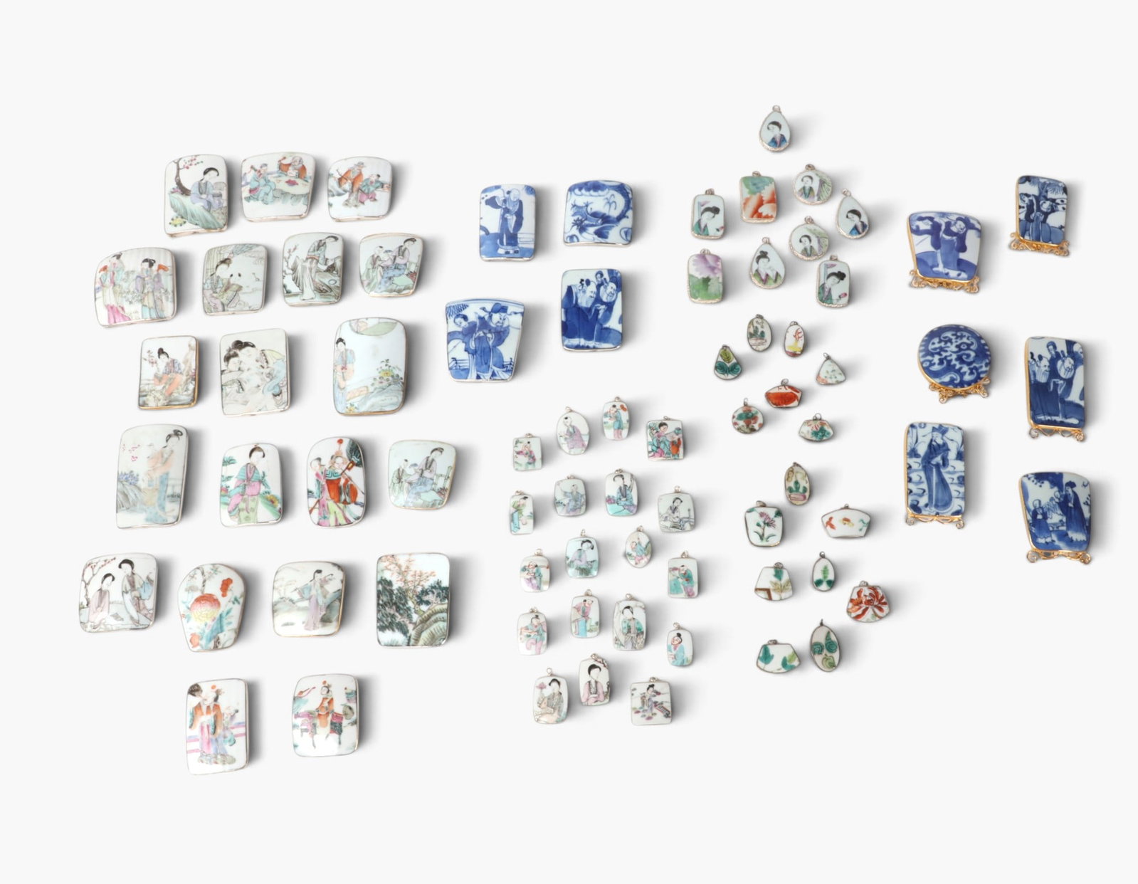 A large collection of Chinese mixed metal mounted glazed porcelain shard pendants and decorations: A large collection of Chinese mixed metal mounted glazed porcelain shard pendants and decorations (approximately 72 pieces) Comprising assorted blue and white glazed porcelain and polychrome painted