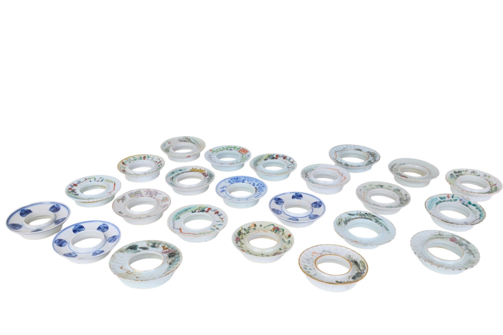 A group of twenty three Chinese porcelain stands: A group of twenty three Chinese porcelain stands Largest: height 1 x diameter 4 in. (2.5 x 10.2 cm.)