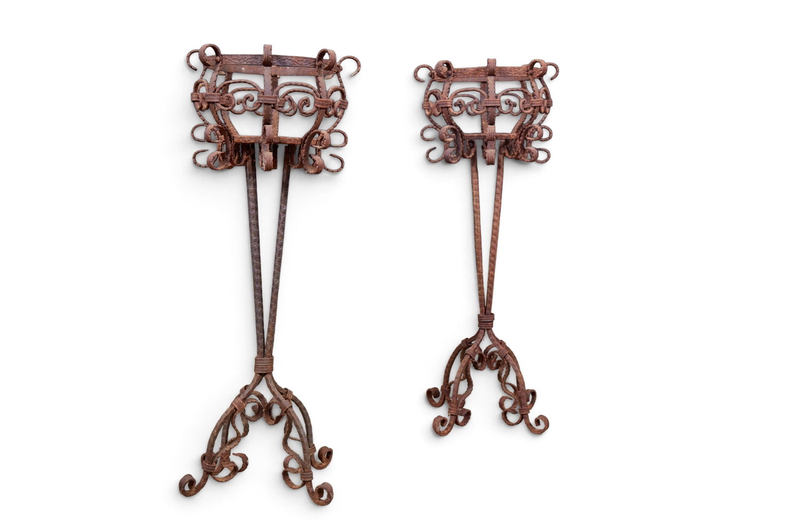 A pair of two wrought iron raised plant stands: A pair of two wrought iron raised plant stands height 36 x diameter 14 in. (91.4 x 35.6 cm.)