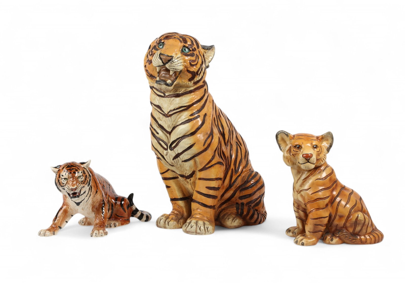 Three glazed ceramic models of seated tigers, One by the Townsends, modern: Three glazed ceramic models of seated tigers One by the Townsends modern largest height 26in (66cm); width 11 1/2in (29cm); depth 21in (53cm)