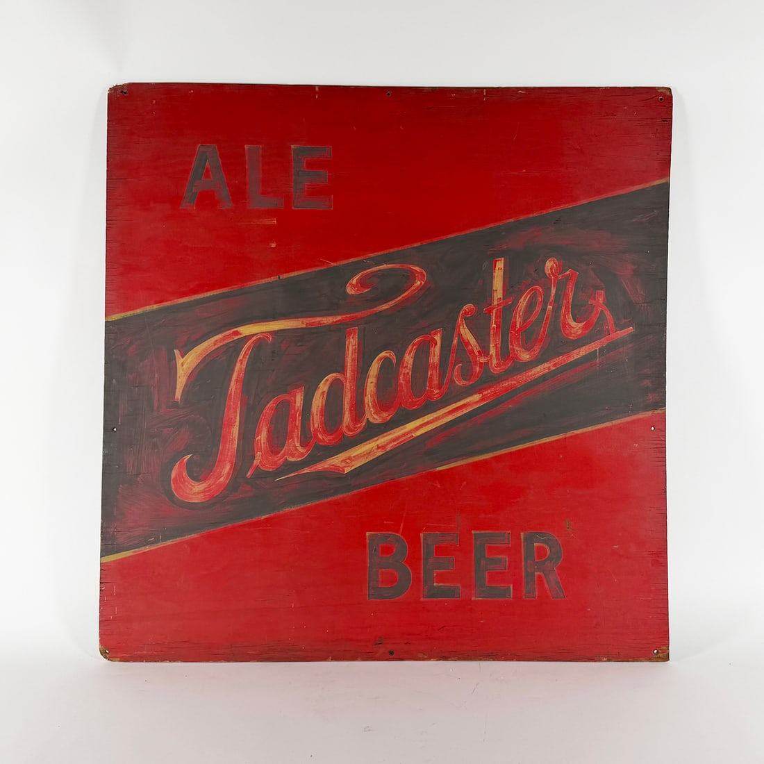 Tadcaster Ale & Beer Wooden Sign: Worcester Brewing. Worcester, Massachusetts. Circa 1940s Tadcaster Ale Beer sign. Painted wood. Features the Tadcaster logo in black and gold on a red background. Sign reads 'Ale' and